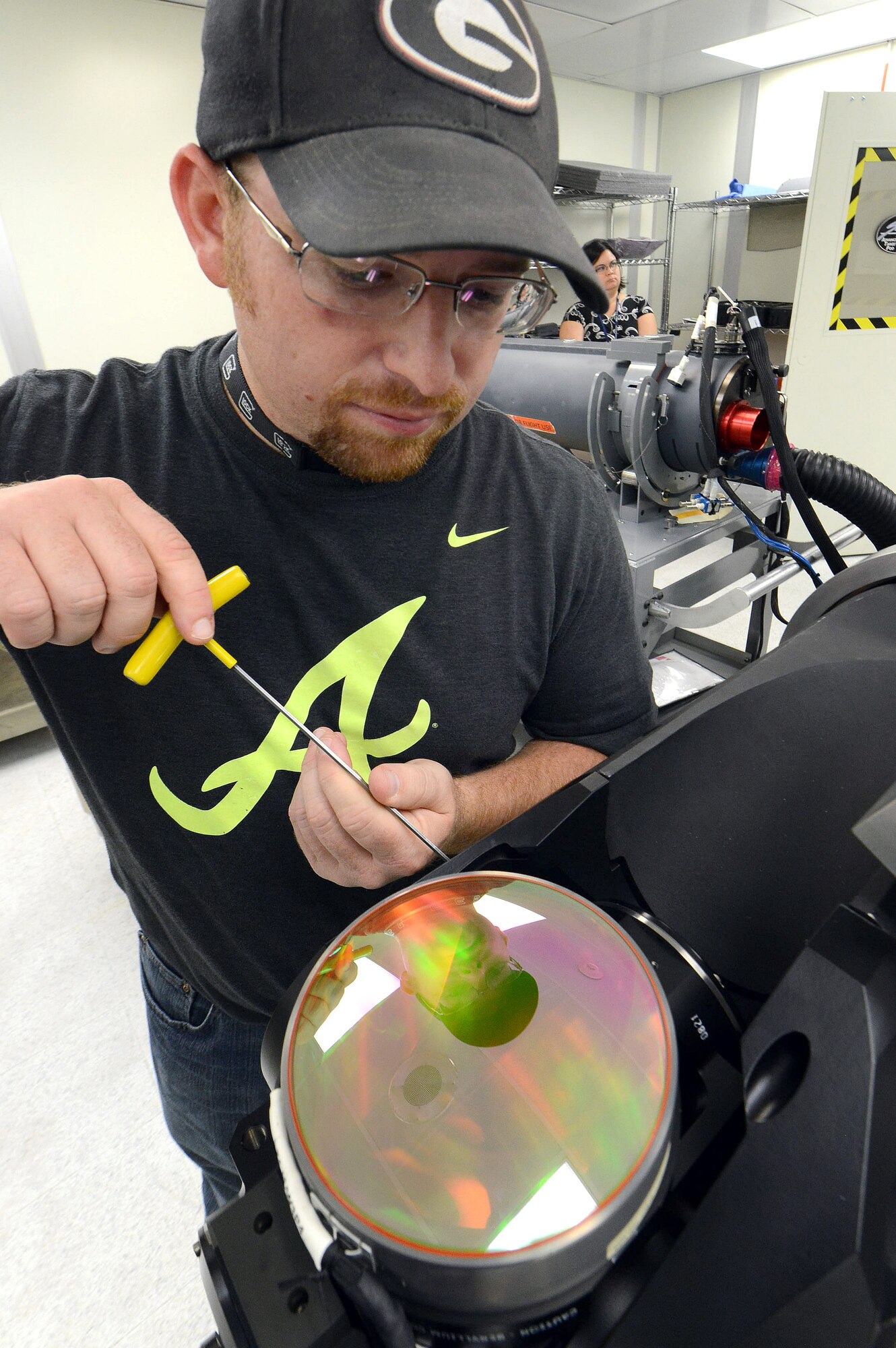 Jeffrey Nauss, 402nd Electronics Maintenance Group electronics technician, performs optic alignment and adjustment procedures on the rotating gimble assembly of a Sniper XR Advanced Targeting Pod.(U.S. Air Force photo by Tommie Horton)