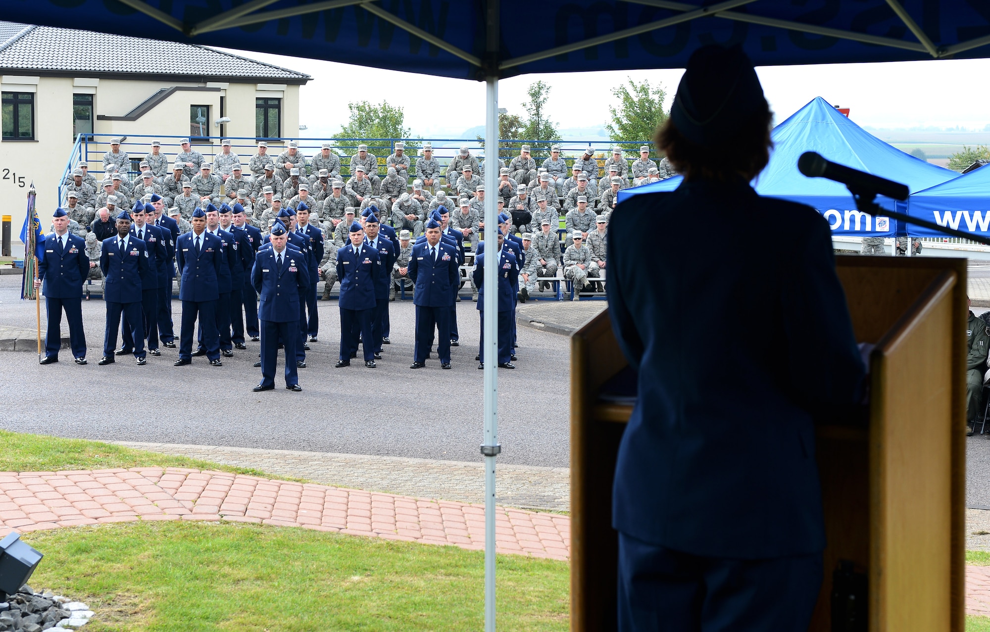 Airmen listen to the keynote speaker during a 9/11 memorial ceremony at the Spangdahlem Air Park here Sept. 11, 2014. The speaker was U.S. Air Force Maj. Carol Crisp, family nurse practitioner at the 52nd Medical Operations Squadron, who was stationed at Andrews Air Force Base in Maryland and shared he recollection of the 9/11 events. (U.S. Air Force Photo by Airman 1st Class Luke J. Kitterman/Released)