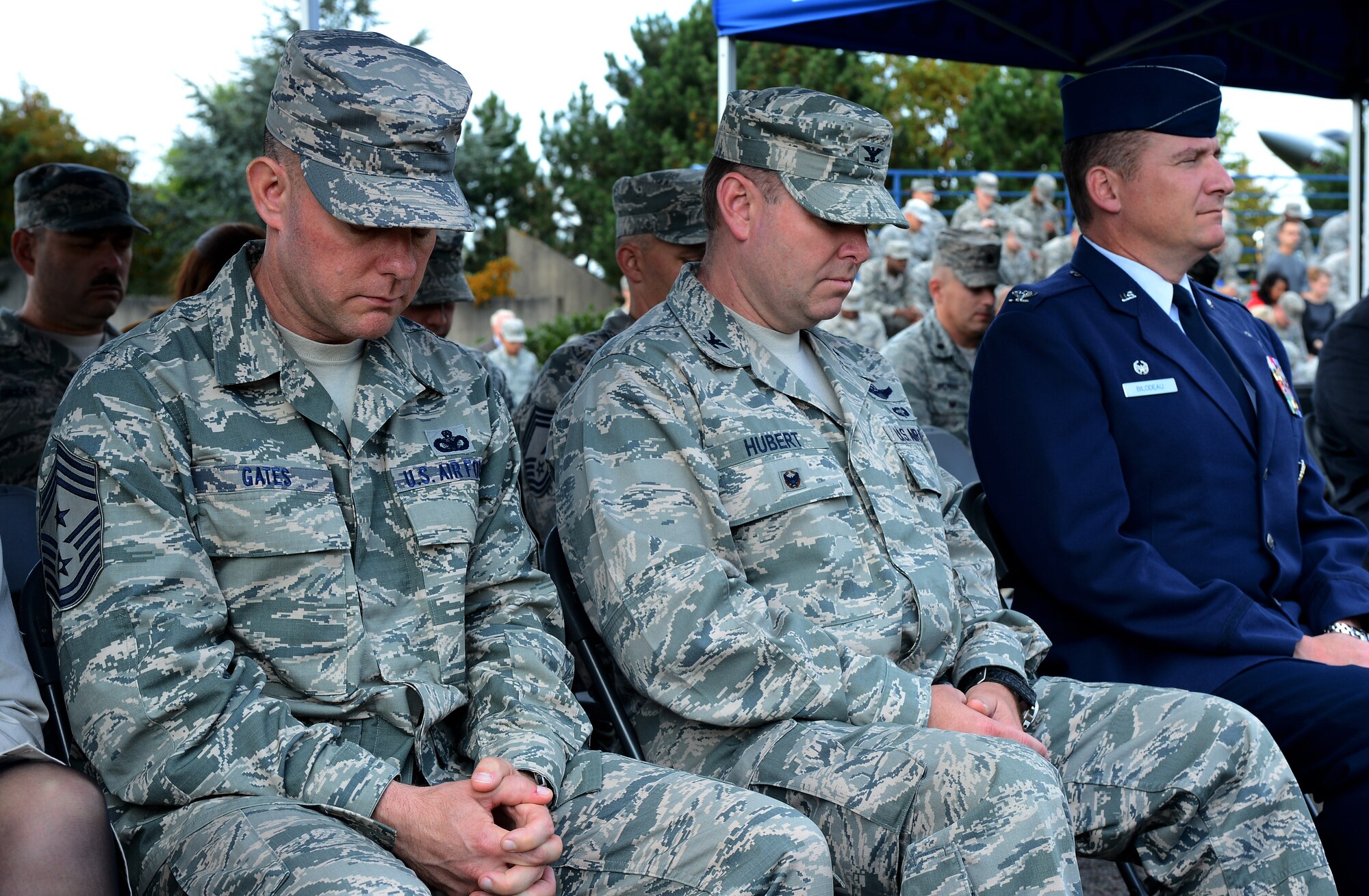From left to right, U.S. Air Force Chief Master Sgt. Brian Gates, 52nd Fighter Wing command chief; U.S. Air Force Col. Lars Hubert, 52nd FW vice commander; and U.S. Air Force Col. Pete Bilodeau, 52nd FW commander, take a moment of silence during a 9/11 ceremony at the Spangdahlem Air Park Memorial Sept. 11, 2014, at Spangdahlem Air Base, Germany. The ceremony started at 2:46 p.m., or 8:46 a.m. EST, the exact time the first plane struck the North Tower in New York City. (U.S. Air Force Photo by Airman 1st Class Luke J. Kitterman/Released)