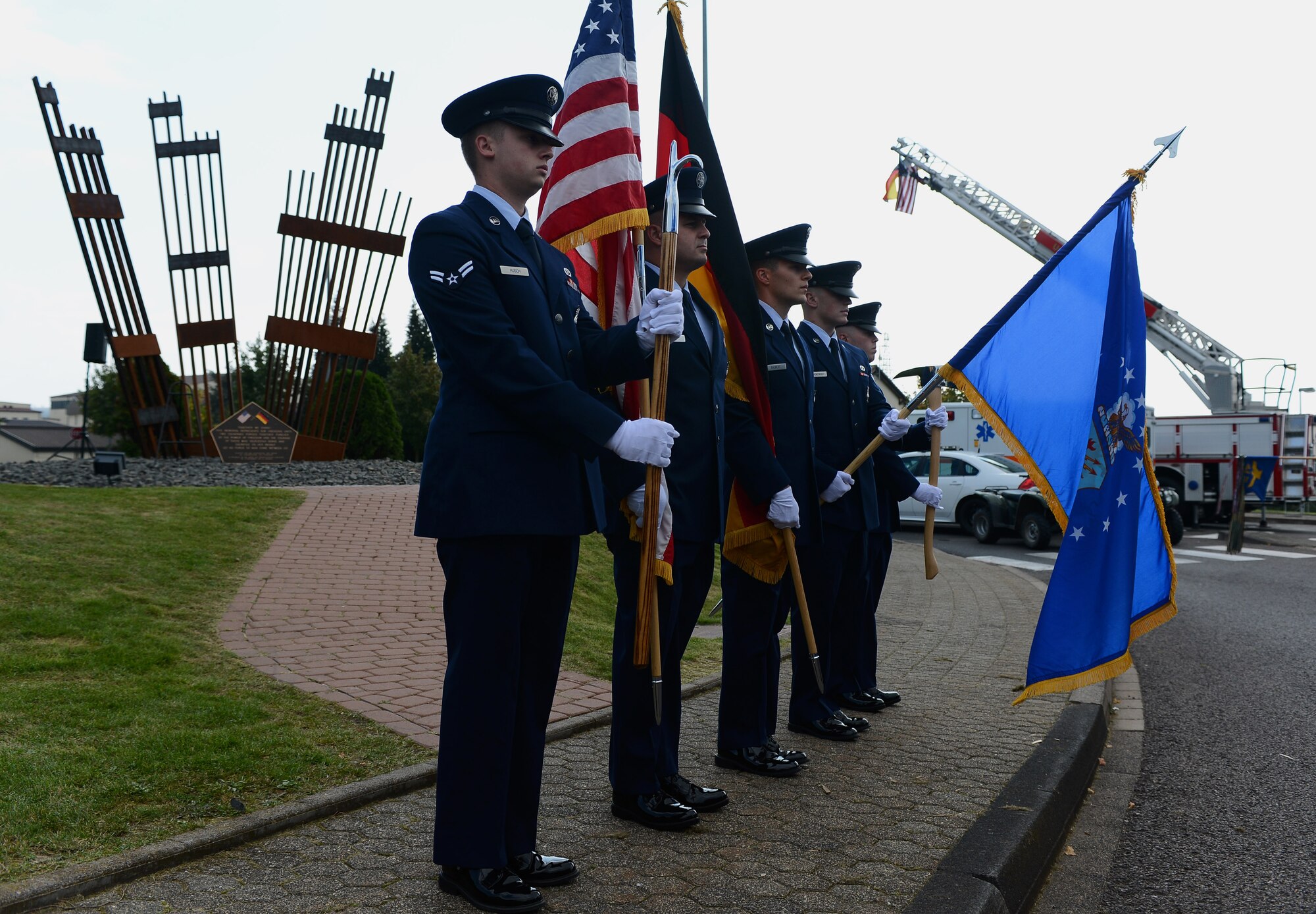 Firefighters from the 52nd Civil Engineer Squadron present the colors during a 9/11 ceremony at the Spangdahlem Air Park Memorial Sept. 11, 2014, at Spangdahlem Air Base, Germany. This was the 13th anniversary of the 9/11 attack, and the ceremony consisted of a wreath laying and speeches. (U.S. Air Force Photo by Airman 1st Class Luke J. Kitterman/Released)