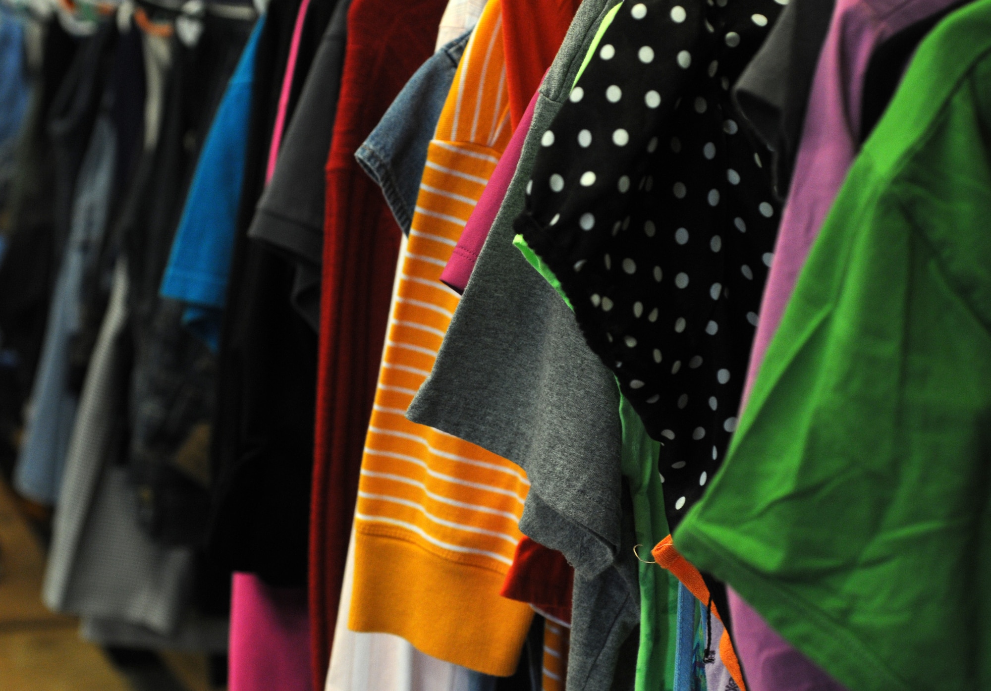 Donated clothes are displayed on a clothes rack Sept. 10, 2014, in the community closet on RAF Mildenhall, England. The community closet is open Mondays, Wednesdays and Fridays from 10 a.m. to 2 p.m. and can be reached at DSN 238-4606 and commercial at 01638 544606. (U.S. Air Force photo/Gina Randall/Released)