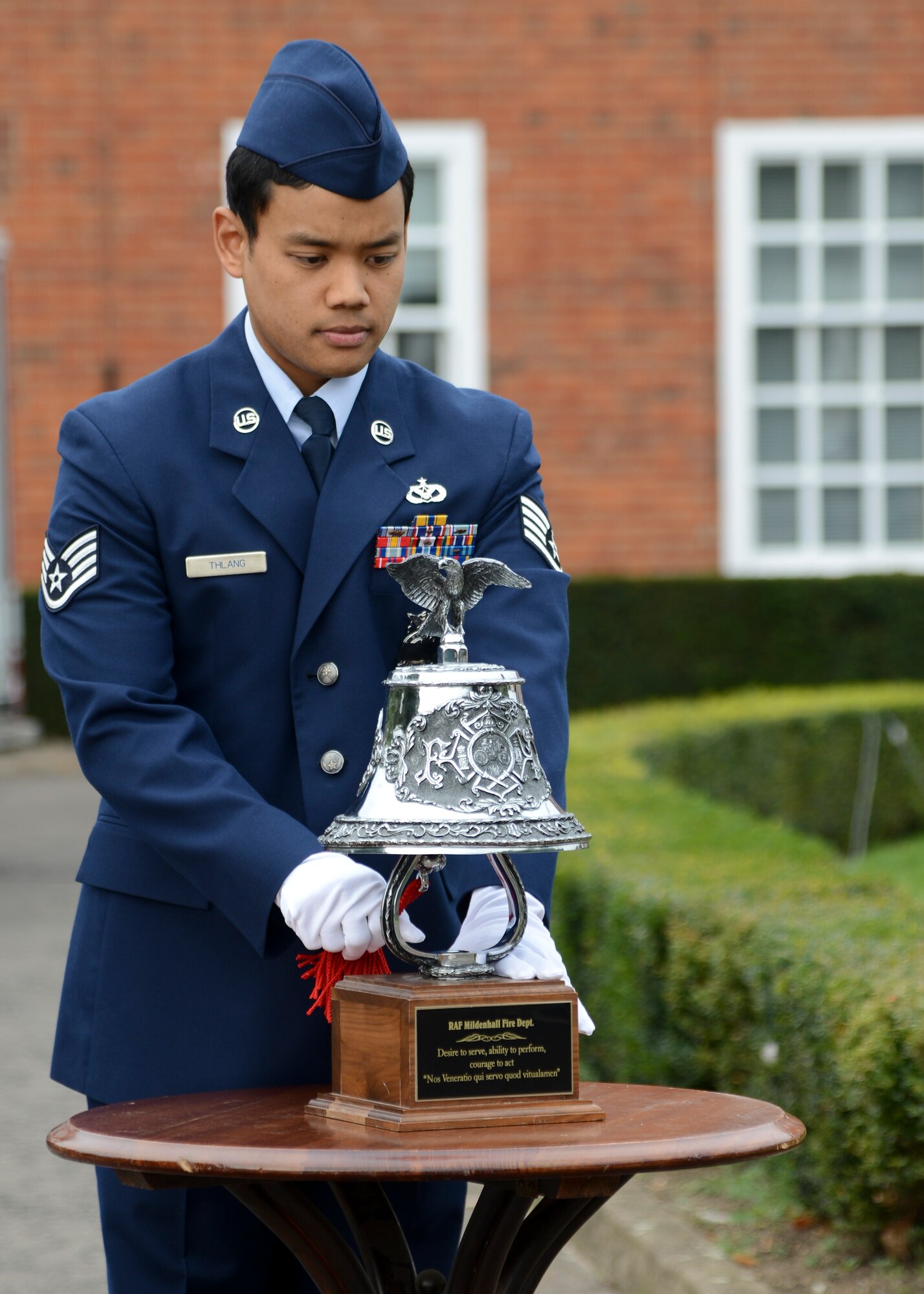 U.S. Air Force Staff Sgt. Anthony Thlang, 100th Civil Engineer Squadron Fire Department firefighter from Seattle, rings the “Last Shift Bell” during a 9/11 memorial retreat ceremony Sept. 11, 2014, on RAF Mildenhall, England. Originally, the bell was used to signify the end of a shift, but during this ceremony Airmen rang the bell to pay tribute to the victims of the 9/11 terrorist attacks. (U.S. Air Force photo/Senior Airman Victoria H. Taylor/Released)