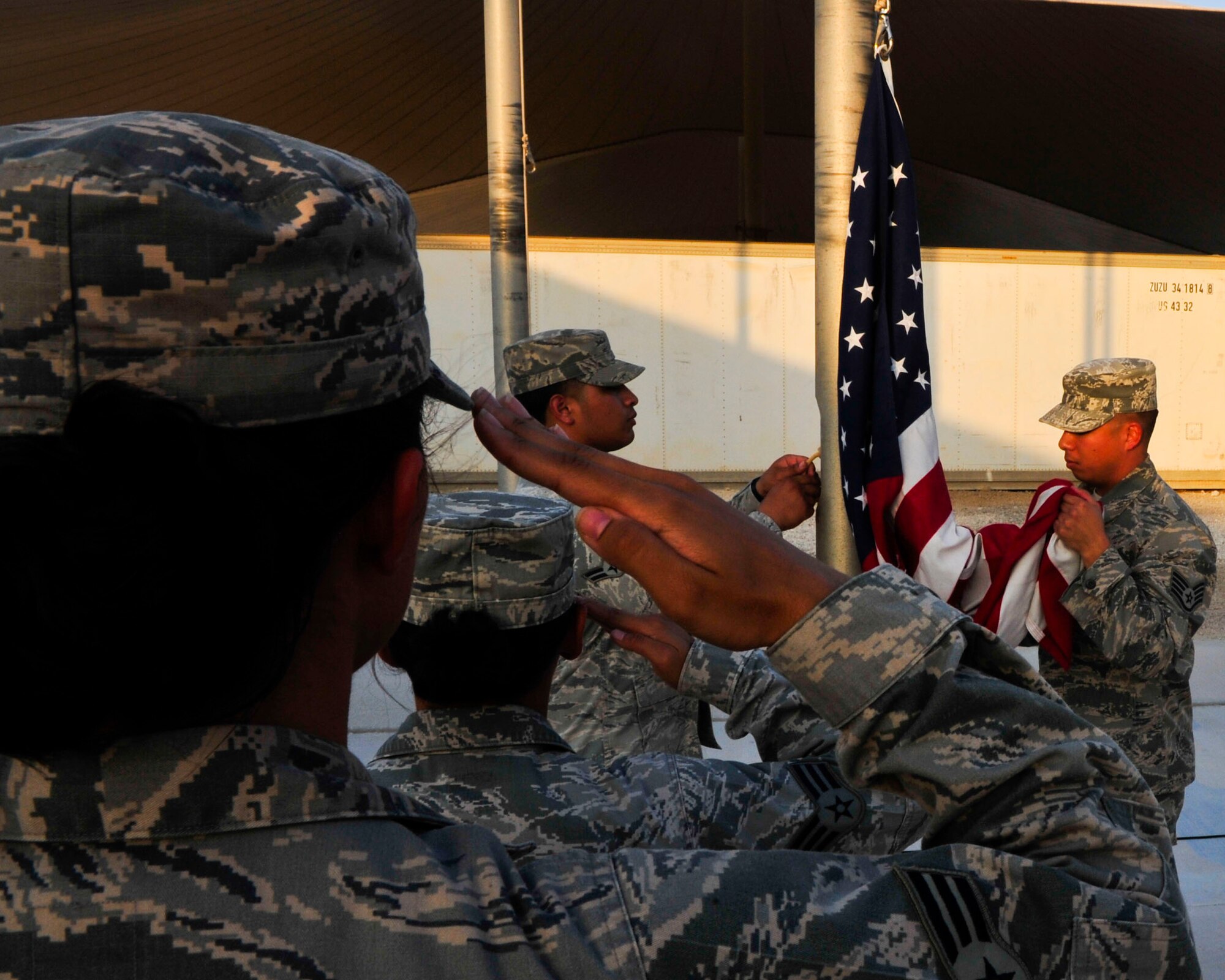 U.S. Air Force Airmen stand in formation during a retreat ceremony recognizing the thirteenth anniversary of the Sept. 11, 2001, at Al Udeid Air Base, Qatar, Sept. 11, 2014.The retreat ceremony signals the end of the official duty day and serves as a ceremony for paying respect to the flag. In this ceremony, respect was paid to the flag and the memory of those lost on Sept. 11, 2001. (U.S. Air Force photo by Senior Airman Colin Cates)  