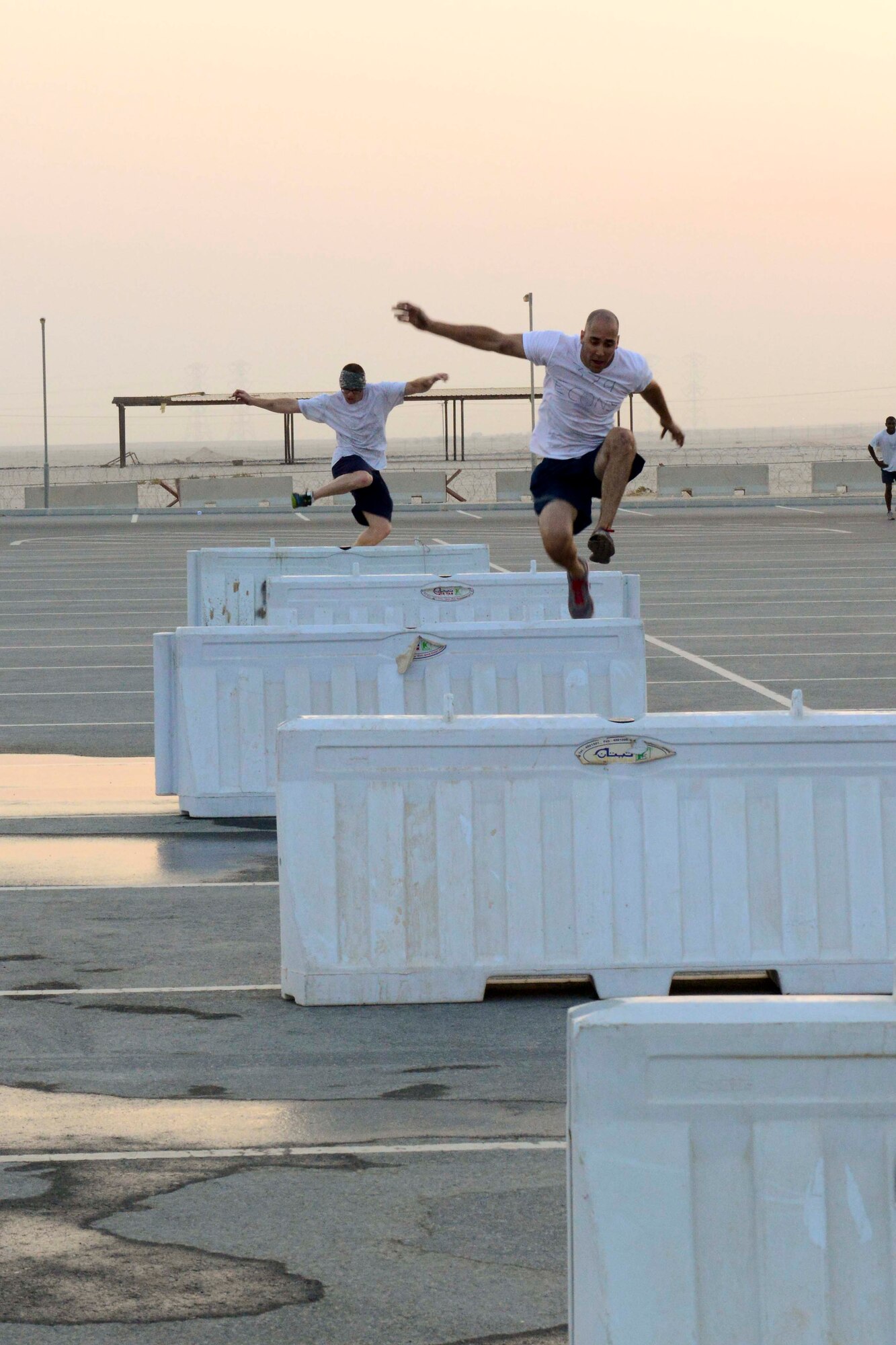 Service members complete an obstacle course during a Combined Federal Campaign kick-off event at Al Udeid Air Base, Qatar, Sept. 8, 2014. The CFC is a program that is known to be the most inclusive workplace giving campaign in the world with the number of participating charities estimated at over 20,000 nonprofit charitable organizations worldwide.  (U.S. Air Force photo by Staff Sgt. Ciara Wymbs)