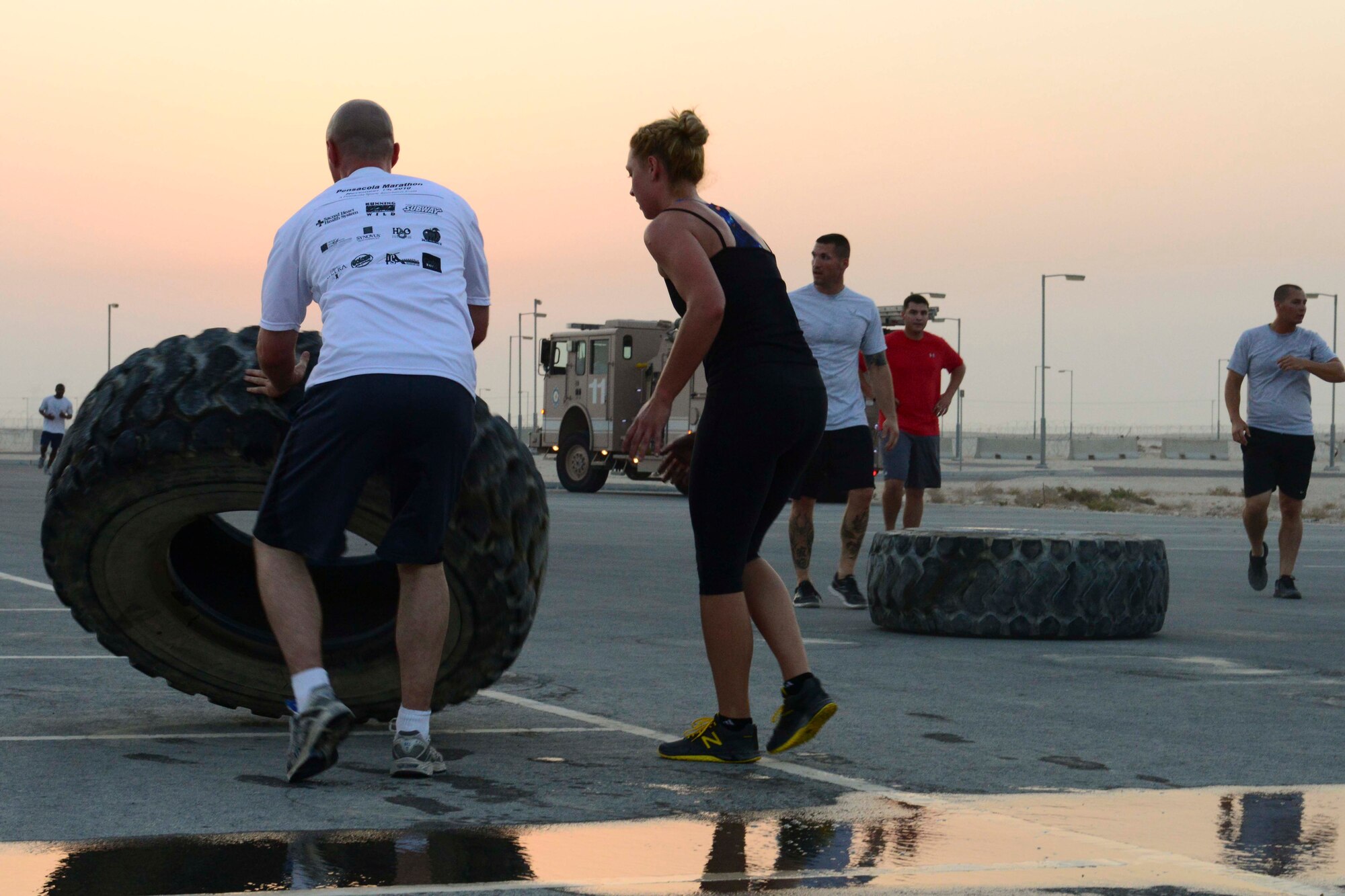 Service members participate in a Combined Federal Campaign kick-off event at Al Udeid Air Base, Qatar, Sept. 8, 2014. The CFC is a program that is known to be the most inclusive workplace giving campaign in the world with the number of participating charities estimated at over 20,000 nonprofit charitable organizations worldwide. (U.S. Air Force photo by Staff Sgt. Ciara Wymbs)