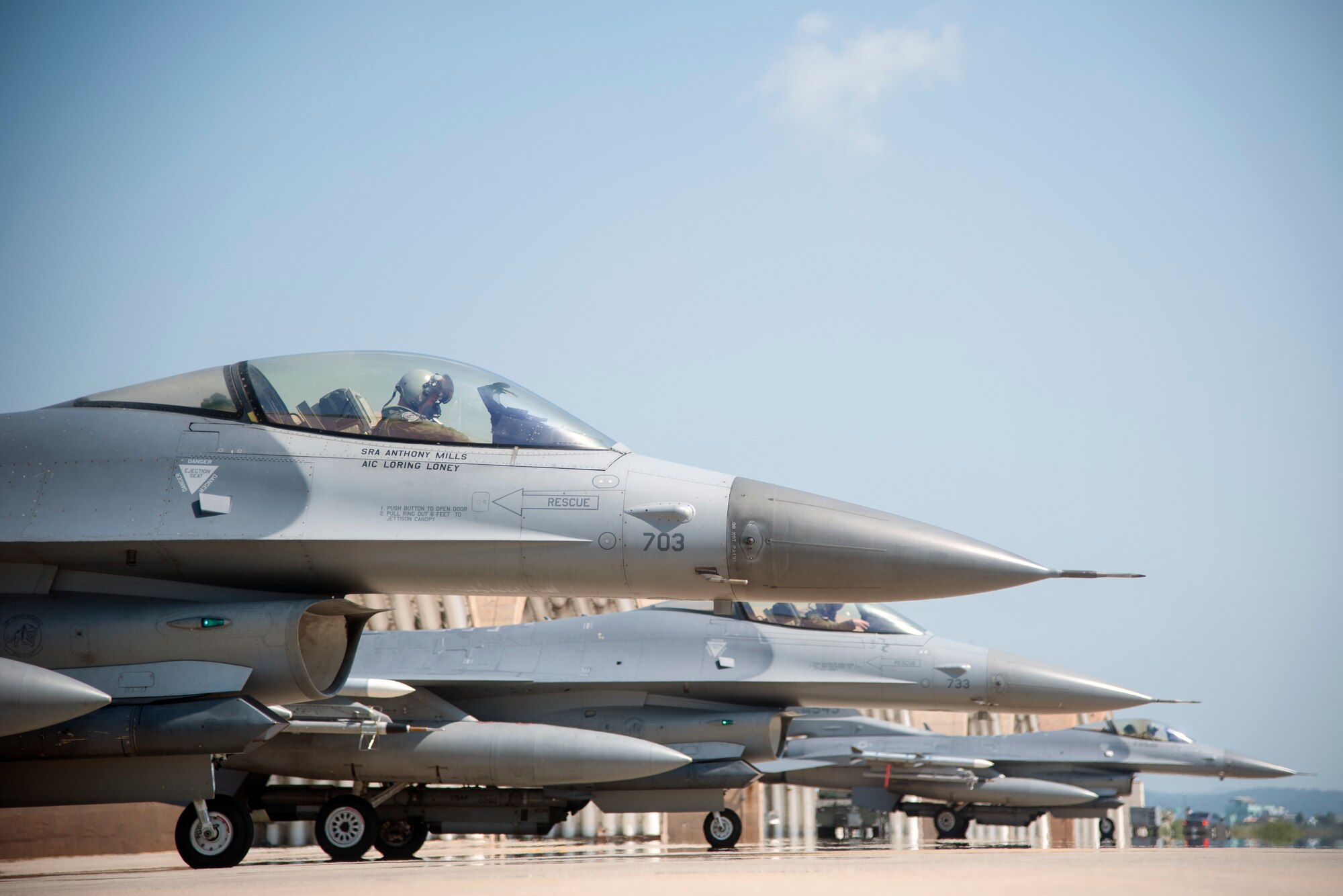 F-16 Fighting Falcons prepare to taxi to the runway at Kunsan Air Base, Republic of Korea, Sept. 10, 2014. The jets will be temporarily operating flying missions out of Osan AB while the runway at Kunsan is under construction for repairs. (U.S. Air Force photo by Senior Airman Taylor Curry/Released)