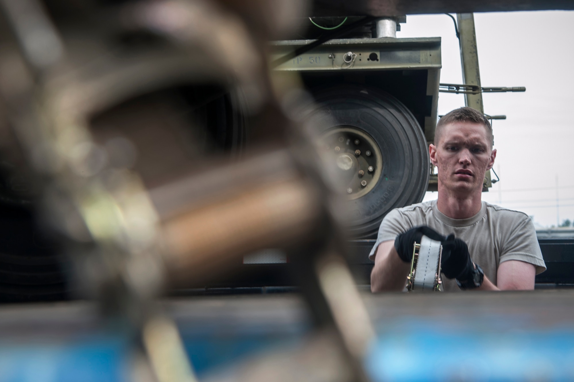 Airman 1st Class Ian Acorn, 8th Logistics Readiness Squadron vehicle operator, straps cargo onto a long-bed truck at Kunsan Air Base, Republic of Korea, Sept. 9, 2014. The equipment is being sent to Osan AB to support 8th Fighter Wing flying operations while the runway at Kunsan undergoes construction.  (U.S. Air Force photo by Senior Airman Taylor Curry/Released)
