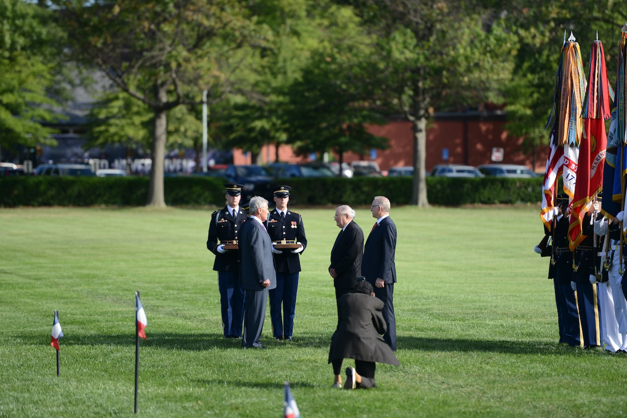 Defense Secretary Chuck Hagel, left, prepares to present awards to Sen. Carl M. Levin, center, chairman of the Senate Armed Services Committee, and Rep. Howard “Buck” McKeon, chairman of the House Armed Services Committee, during a farewell ceremony at Joint Base Myer-Henderson Hall, Va., Sept. 12, 2014. DoD photo by Army Sgt. 1st Class Tyrone C. Marshall Jr.