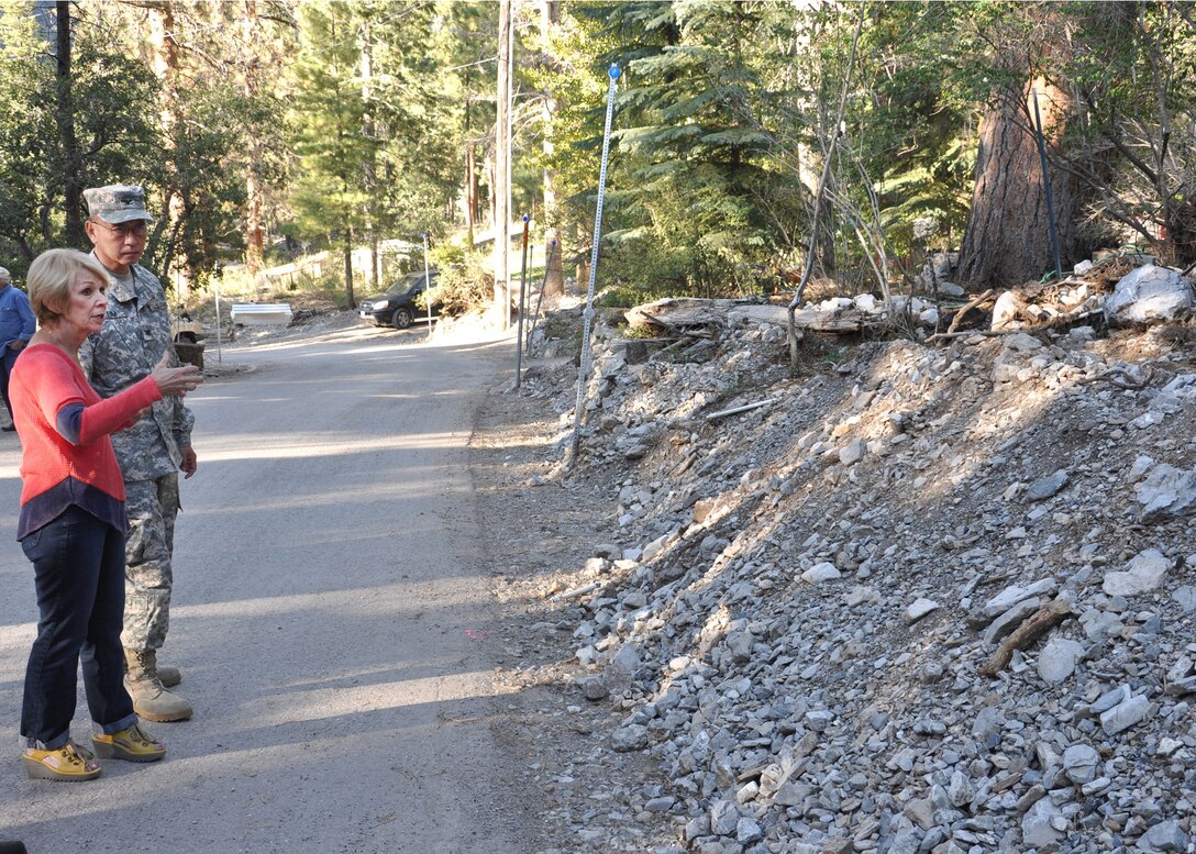 Col. John Lim, the U.S. Army Corps of Engineers Los Angeles District acting commander, speaks with Becky Grismanauskas, outside her home in Mt. Charleston, Nev. before a Sept. 12 public meeting. The District held a public meeting with officials from the USDA Forest Service, the State of Nevada and other local agencies at the Mount Charleston Volunteer Fire Department Engine Station #81 to discuss the berm and diversion channel the District will be constructing.