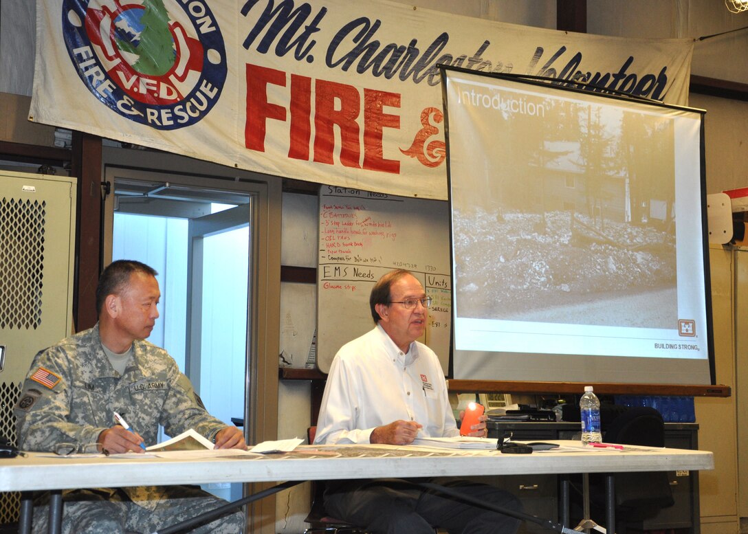 Col. John Lim, the U.S. Army Corps of Engineers Los Angeles District acting commander, and Richard Leifield, the District’s chief of Engineering Division, discuss the berm and diversion channel the District will be constructing during a Sept. 12 public meeting at the Mount Charleston Volunteer Fire Department Engine Station #81. The temporary structure, approximately 2,200 feet long, will be built on Forest Service land and is designed to divert flows from rain events into a natural wash and away from the neighborhood.