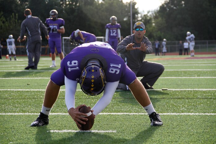 Jaycee D. Pummill, the Blue Springs High School senior long snapper and a 2015 Semper Fidelis All-American Bowl selectee, prepares to snap the ball to his position coach, Nolan Hochgrebe, during warmups before the Wildcats game against the St. Joseph Central High School Indians at Peve Stadium Sept. 12, 2014. Pummill is one of approximately 100 players selected from across the nation to participate in the Semper Fi Bowl next year at the StubHub Center in Carson, Calif.,  on Jan. 4, 2015, and will be aired live on Fox Sports 1 at 6 p.m. Pacific Standard Time.