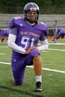 Jaycee D. Pummill, the Blue Springs High School senior long snapper and a 2015 Semper Fidelis All-American Bowl selectee, stretches during warmups before the Wildcats game against the St. Joseph Central High School Indians at Peve Stadium Sept. 12, 2014. The Wildcats routed the Indians 49-7. Pummill is one of approximately 100 players selected from across the nation to participate in the Semper Fi Bowl next year at the StubHub Center in Carson, Calif.,  on Jan. 4, 2015.