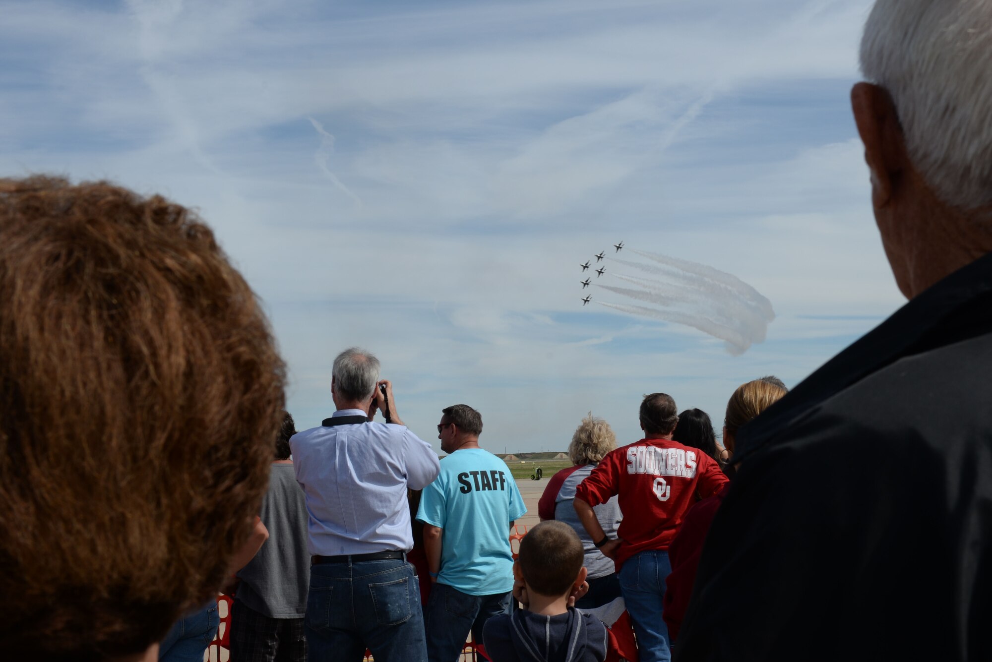 ALTUS AIR FORCE BASE, Okla. – Spectators watch as the U.S. Air Force Thunderbirds fly in a delta formation during the 2014 Wings of Freedom Open House Sept. 13, 2014. The U.S. Air Force Air Demonstration Squadron, better known as the Thunderbirds, performs precision aerial maneuvers demonstrating the capabilities of Air Force high performance aircraft to people throughout the world. The squadron exhibits the professional qualities the Air Force develops in the people who fly, maintain and support these aircraft. (U.S. Air Force Airman 1st Class J. Zuriel Lee/Released)