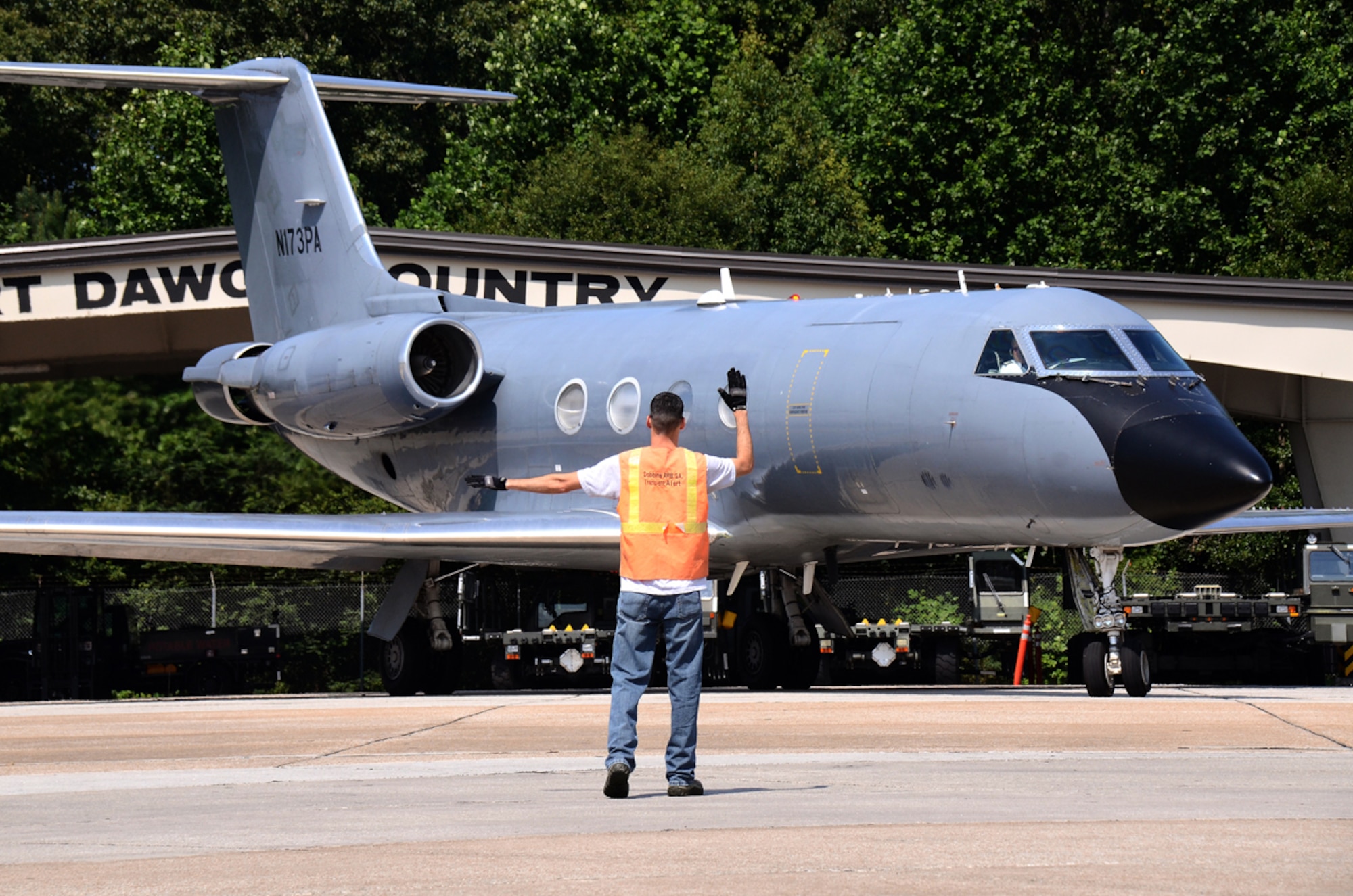 A member of 94th Operations Group trans alert directs the Phoenix Air Gulfstream 3 air ambulance transporting a patient who contracted the Ebola virus, as it taxis at Dobbins Air Reserve Base, Georgia Aug. 5, 2014. The transfer was a team effort of the 94th Airlift Wing, Clay National Guard center, Emory University Hospital, Grady Hospital and the center of Disease Control. (U.S. Air Force photo/Brad Fallin)