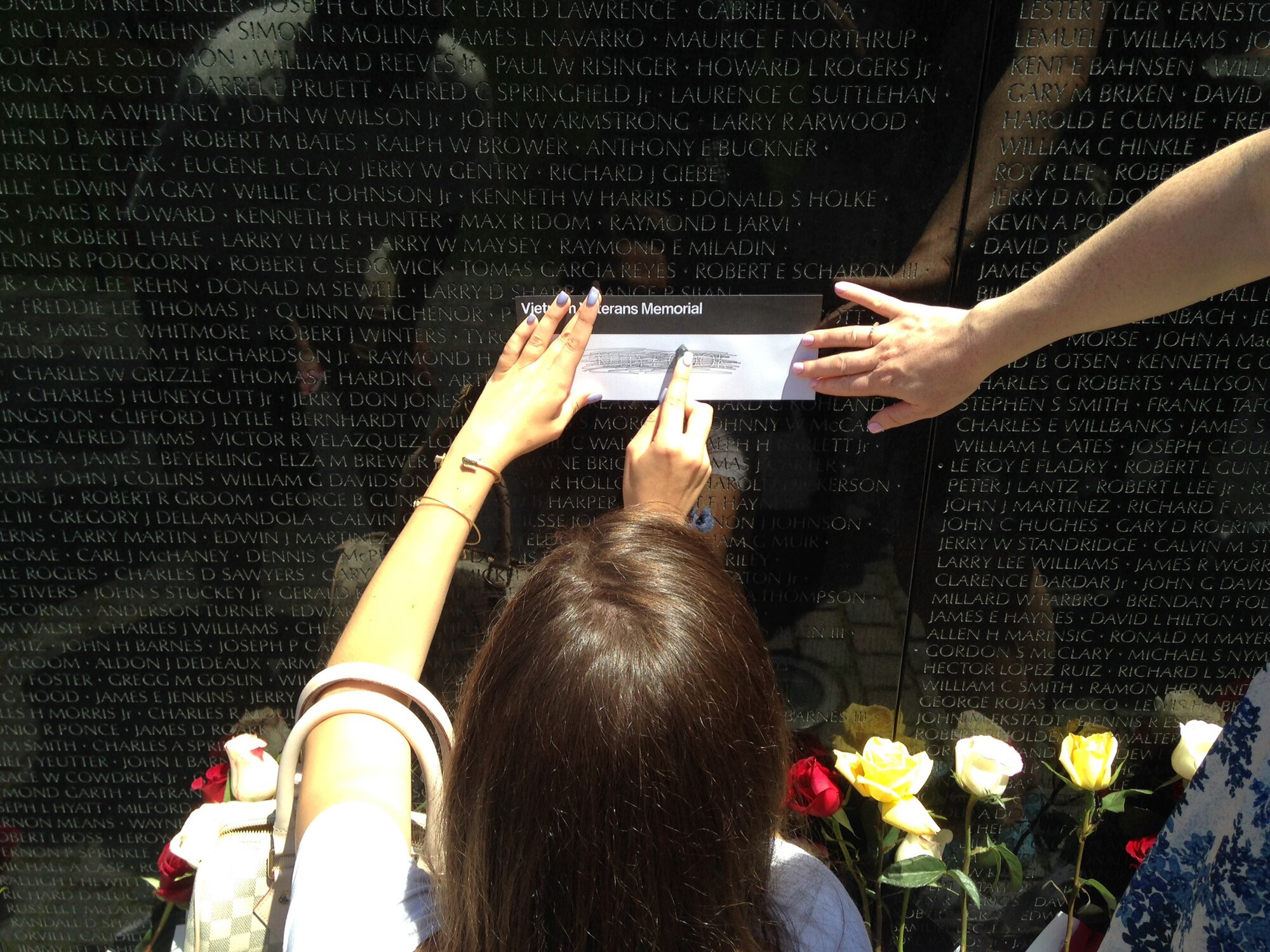 On Father’s Day June 15, 2014, Caroline Kozak, the daughter of Maureen and Col. Raymond A. Kozak, 512th Airlift Wing commander at Dover Air Force Base, Del., rubs a pencil across her grandfather’s name on the Vietnam Veterans Memorial, Washington, D.C. Her grandfather was an Air Force fighter pilot, who was shot down over North Vietnam in 1967 and was listed as missing in action until 1976, when he was declared killed in action, body not recovered. (Submitted photo)