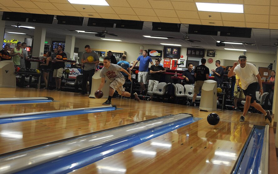 Wolf Pack Airmen compete in a 9 Pin Tap bowling tournament during the Combined Federal Campaign-Overseas kickoff events at Kunsan Air Base, Republic of Korea, Sept. 13, 2014.  Wolf Pack Airmen were granted the opportunity to donate to their charity of choice or make an undesignated donation while participating in a frisbee and bowling tournament throughout the day. (U.S. Air Force photo by Senior Airmen Divine Cox)