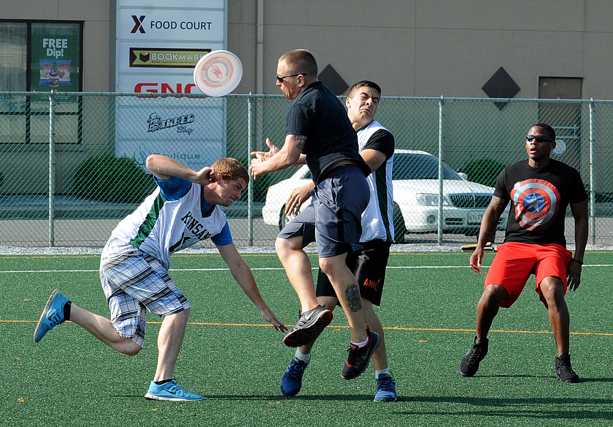 Airmen from the 8th Logistics Readiness Squadron and the 8th Maintenance Squadron munitions flight battle each other for the frisbee during the Combined Federal Campaign-Oversea kickoff events at Kunsan Air Base, Republic of Korea, Sept. 13, 2014.  Airmen came together on a Saturday morning  to support CFC-O by participating in an ultimate frisbee and bowling tournament. (U.S. Air Force photo by Senior Airmen Divine Cox)
