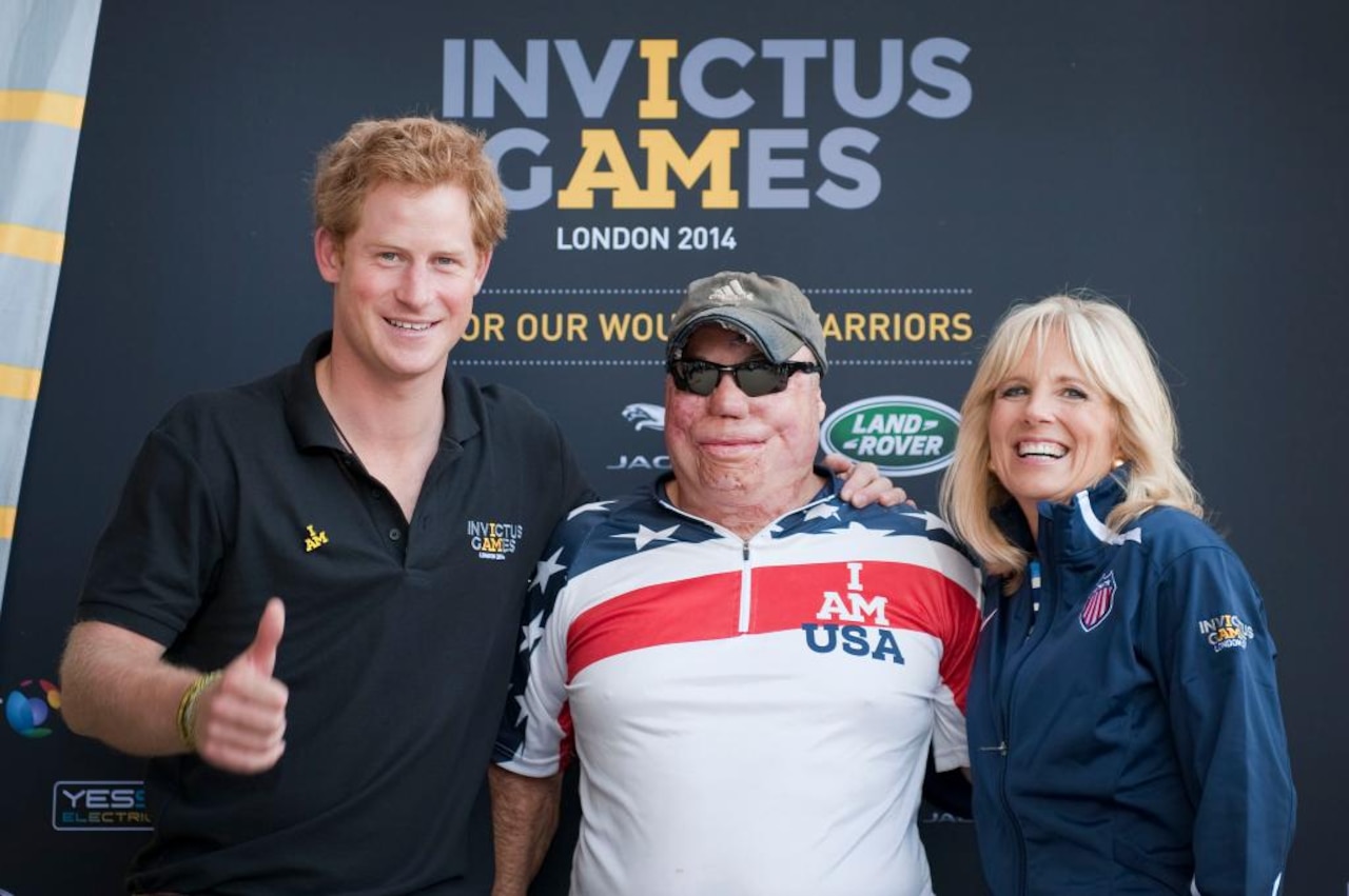Dr. Jill Biden, wife of Vice President Joe Biden, right, and Britain’s Prince Harry flank Team USA athlete Air Force Tech. Sgt. Israel Del Toro Jr. at the 2014 Invictus Games in London, Sept. 13, 2014. Del Toro was injured while serving in Afghanistan in 2005. White House courtesy photo