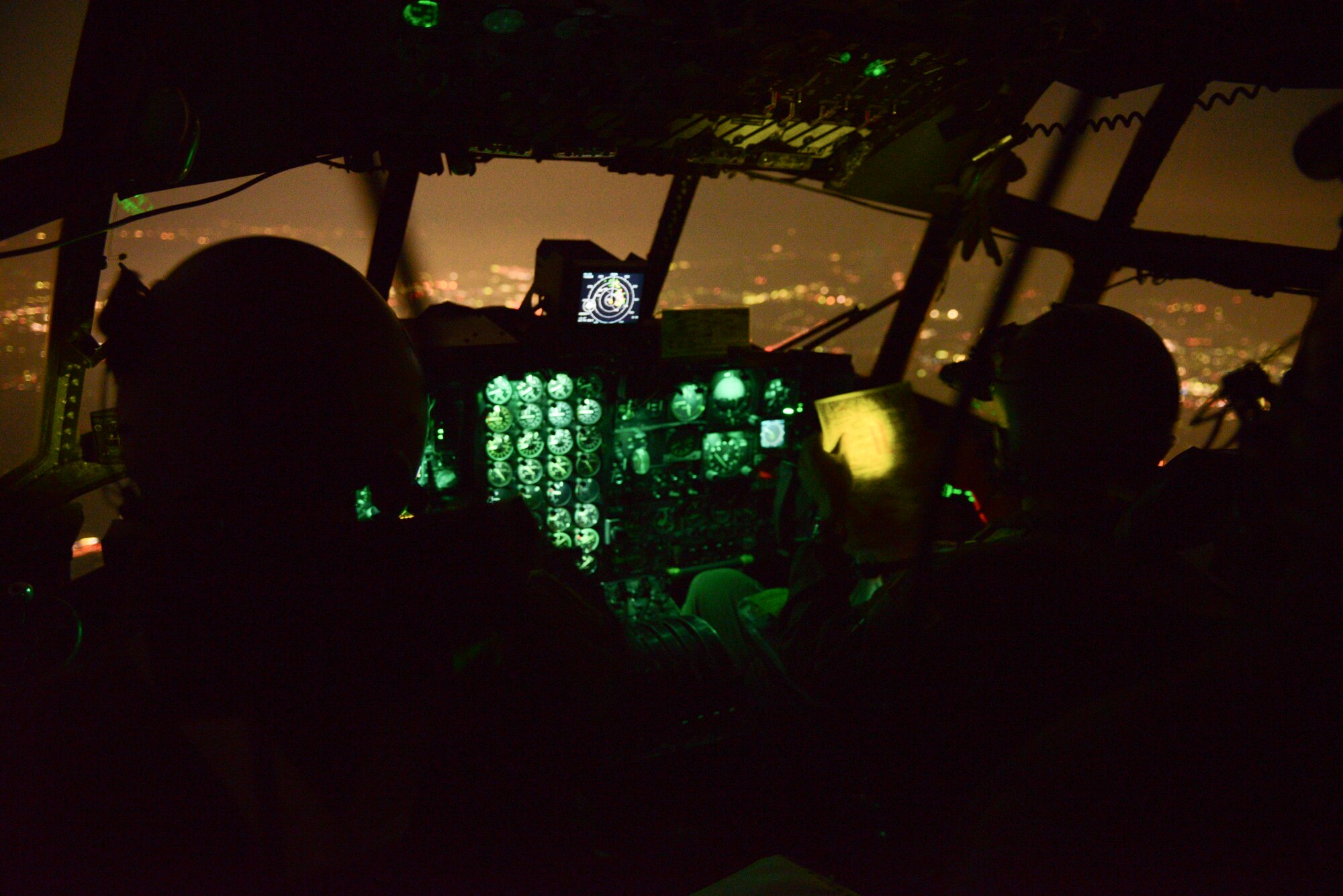 Members with the 36th Airlift Squadron use night vision goggles during routine flights at Yokota Air Base, Japan, Sept. 11, 2014. The U.S. Air Force aircrew also used the flight as an opportunity to showcase their night vision goggle capabilities with their Japan Air Self-Defense Force partners. (U.S. Air Force photo by Staff Sgt. Cody H. Ramirez/Released)