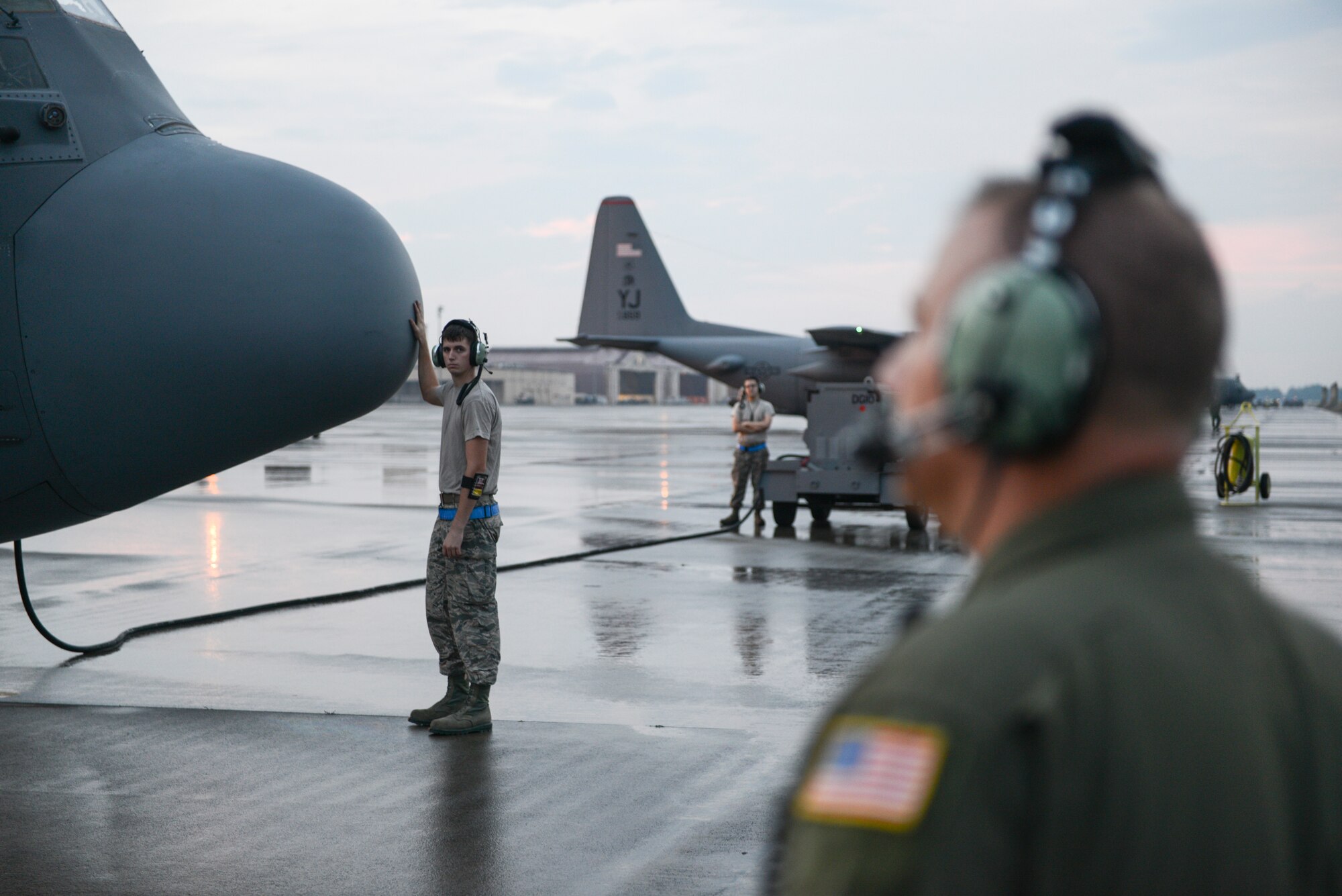 A crew chief with the 374th Aircraft Maintenance Squadron rubs the nose of a C-130 Hercules for good luck before a flight at Yokota Air Base, Japan, Sept. 11, 2014. The C-130 Hercules contained a team of 36th Airlift Squadron aircrew who were showcasing their night vision goggle capabilities to Japan Air Self-Defense Force aircrew. (U.S. Air Force photo by Staff Sgt. Cody H. Ramirez/Released) 