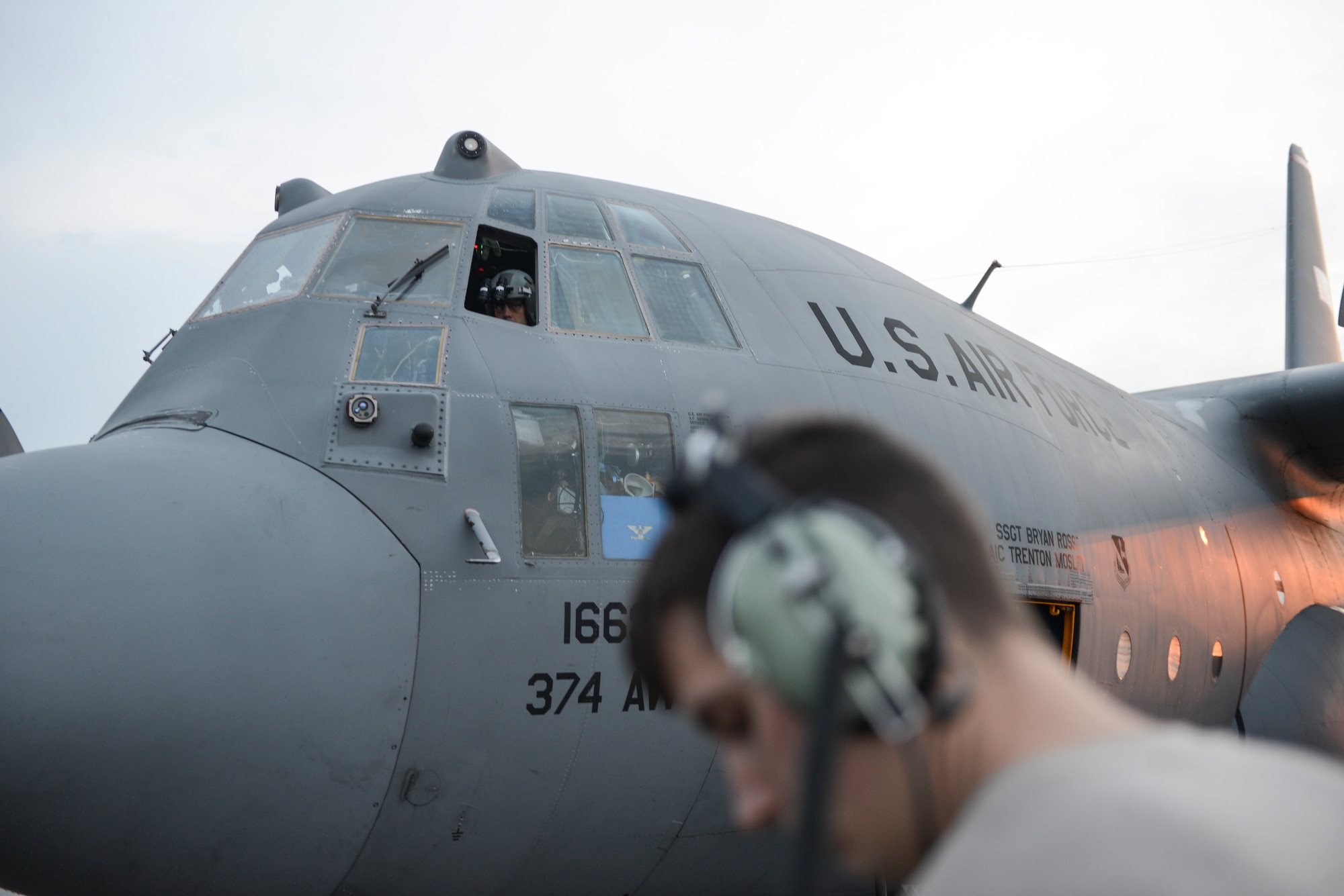 Lt. Col Andrew Campbell, 36th Airlift Squadron commander, coordinates an engine check with a crew chief at Yokota Air Base, Japan, Sept. 11, 2014. Campbell headed a team of 36 AS aircrew who showcased their night vision goggle capabilities to Japan Air Self-Defense Force members. (U.S. Air Force photo by Staff Sgt. Cody H. Ramirez/Released)