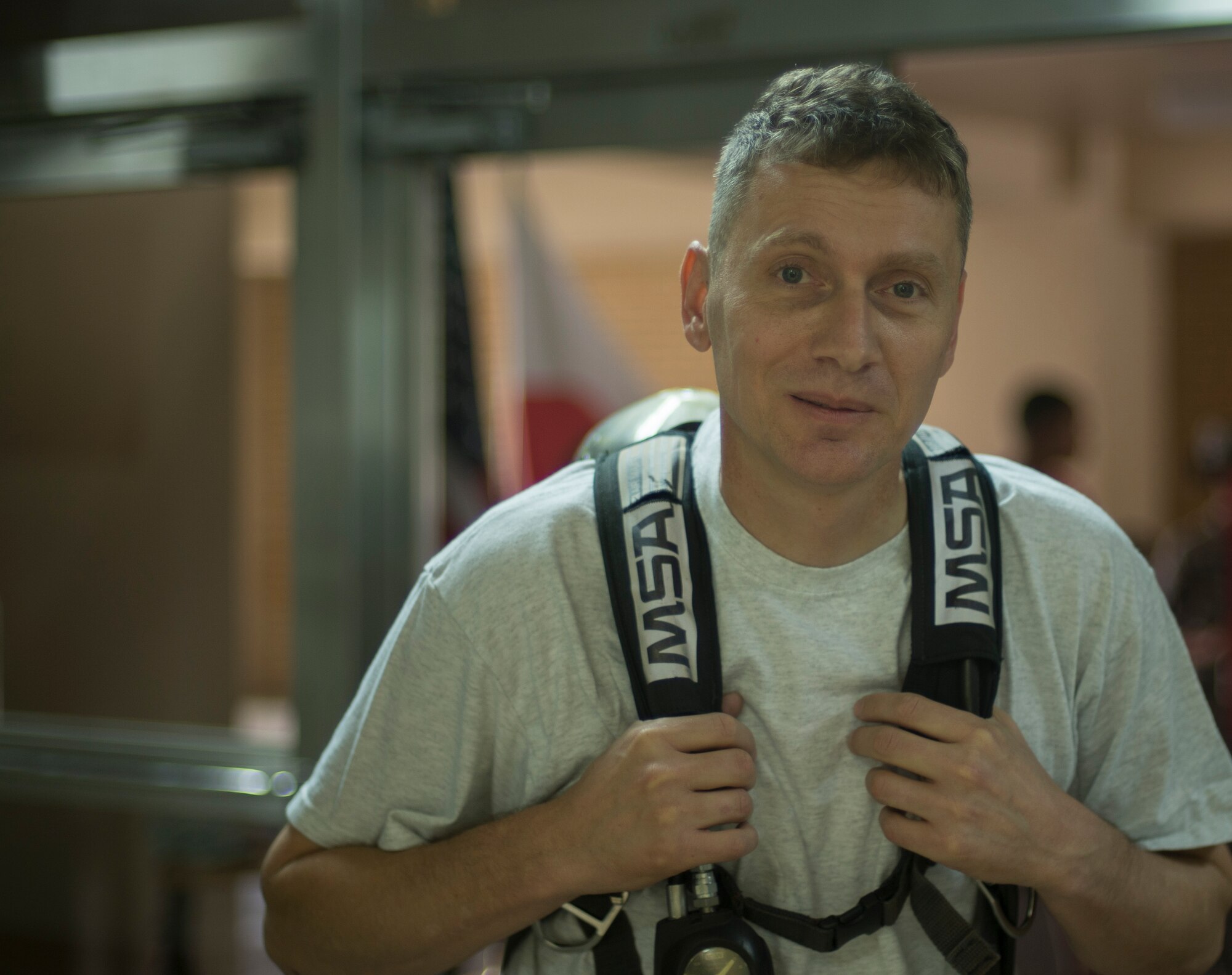 Lt. Col. David McCleese, 374 Civil Engineer Squadron commander, poses for a picture before running up to the ninth floor of a base tower during the Sept. 11 Tower Run at Yokota Air Base, Japan, Sept. 11, 2014. The event is to pay homage to the firefighters who lost their lives during the attacks of 9/11. (U.S. Air Force photo by Senior Airman Michael Washburn/released)