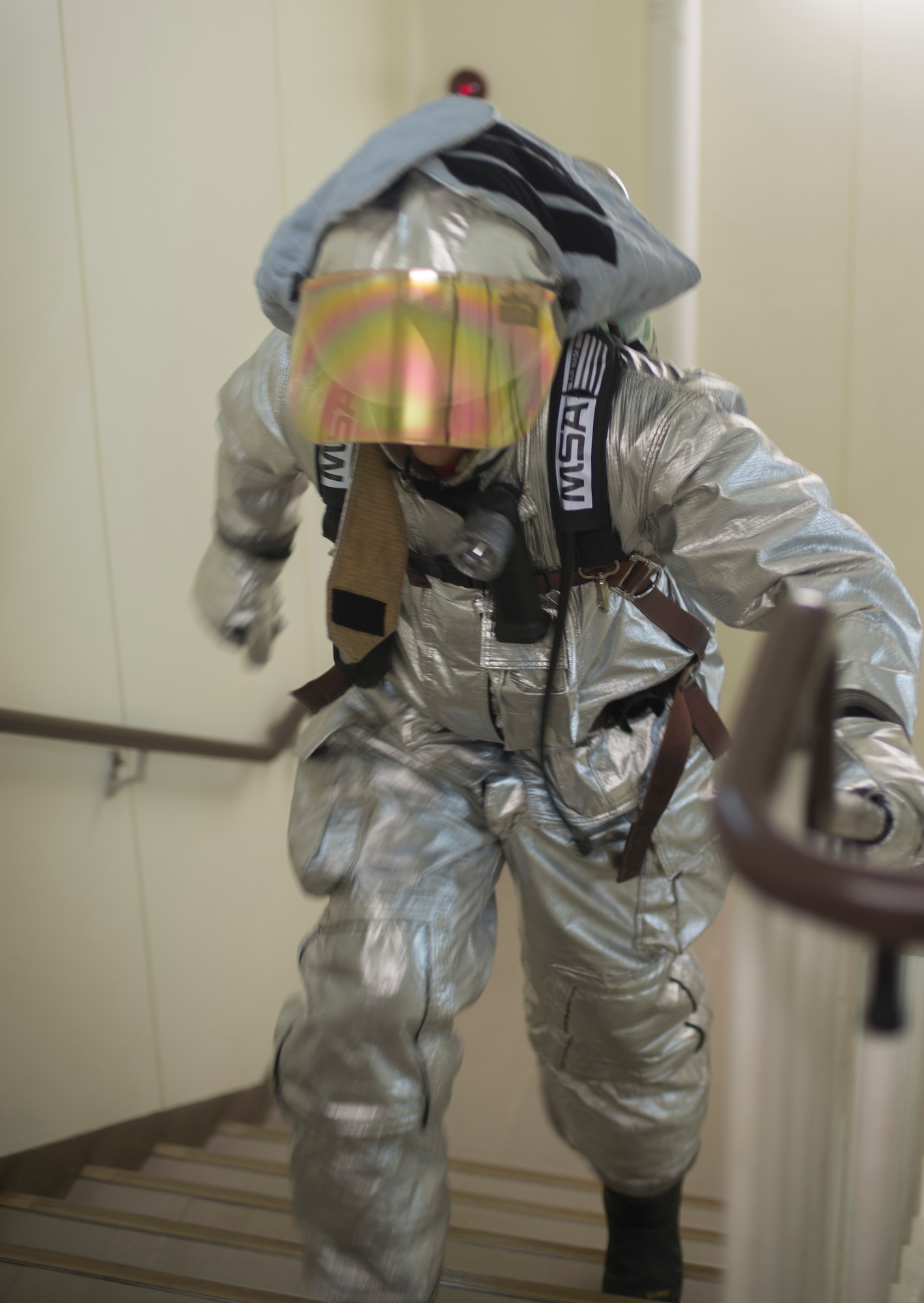An Airman with the 374 Civil Engineer Squadron fire department runs up a flight of stairs during the Sept. 11 Tower Run at Yokota Air Base, Japan, Sept. 11, 2014. The event is to pay homage to the firefighters who lost their lives during the attacks of 9/11. (U.S. Air Force photo by Senior Airman Michael Washburn/released)