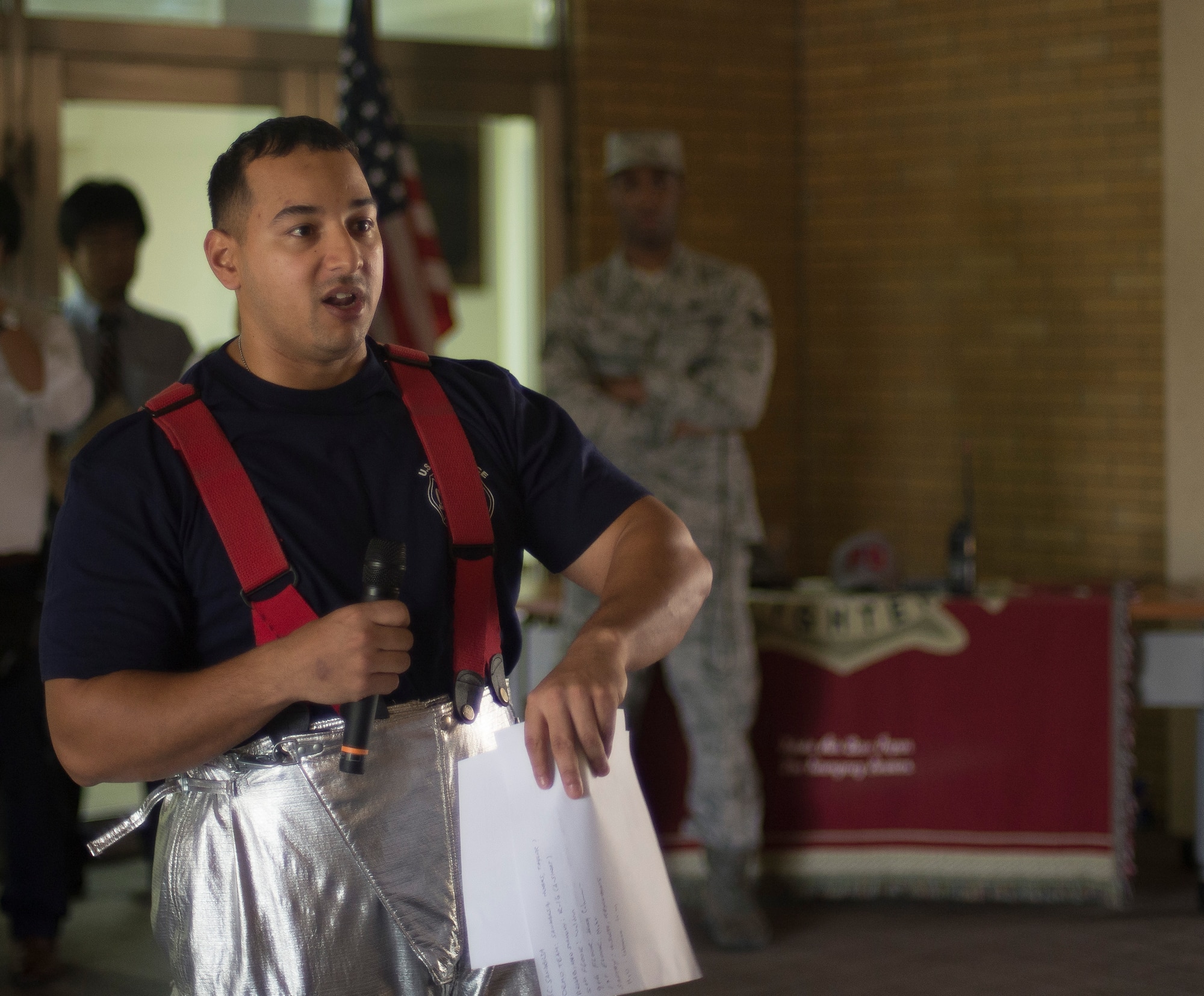Tech. Sgt. Stephen Sanabria, 374 Civil Engineer Squadron firefighter, greets attendees and announces the rules during the Sept. 11 Tower Run at Yokota Air Base, Japan, Sept. 11, 2014. Five teams showed up to participate in the run to honor those firefighters who lost their lives during the attacks of 9/11. (U.S. Air Force photo by Senior Airman Michael Washburn/Released)