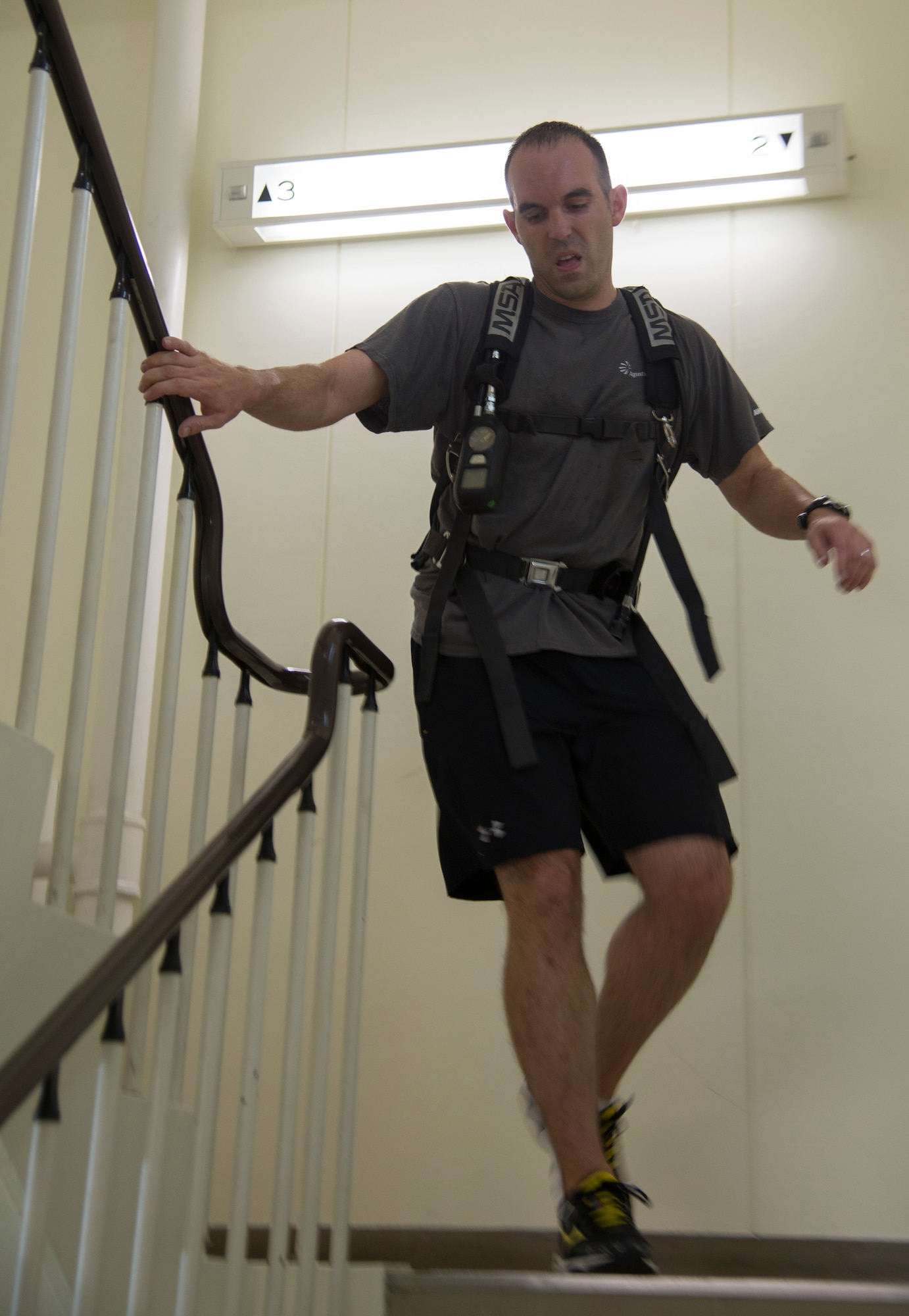An Airman rushes down a flight of stairs during the 2014 Sept. 11 Tower Run at Yokota Air Base, Japan, Sept. 11. Each member of the four-person team ascended and descended the tower twice. (U.S. Air Force photo by Senior Airman Michael Washburn/Released)