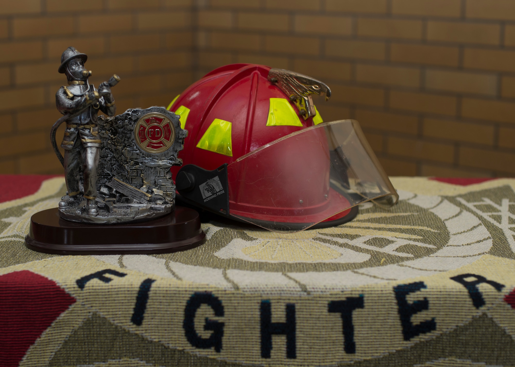 A firefighter helmet sits next to the trophy for the 2014 Sept. 11 Tower Run at Yokota Air Base, Japan, Sept. 11, 2014. The Tower Run represents the 110 floors of the Twin Towers that first responders ascended after the first aircraft attack of 9/11. (U.S. Air Force photo by Senior Airman Michael Washburn/Released)