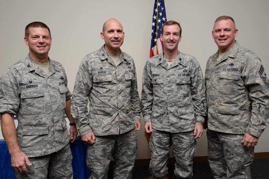 Lt. Col. Edward Segura (second from right), 403rd Maintenance Group deputy commander, poses with 403rd Wing commander Col. Frank Amodeo, 403rd Wing vice commander Col. Michael Manion, and 403rd Wing Command Chief Master Sgt. Christopher Barnby at a ceremony honoring him for receiving the 2014 Air Force Reserve Command General Lew Allen Jr. Award. The award is given annually to honor a base-level officer and a senior NCO working in aircraft, munitions or missile maintenance directly involved in sortie generation. (U.S. Air Force photo/Tech. Sgt. Ryan Labadens)