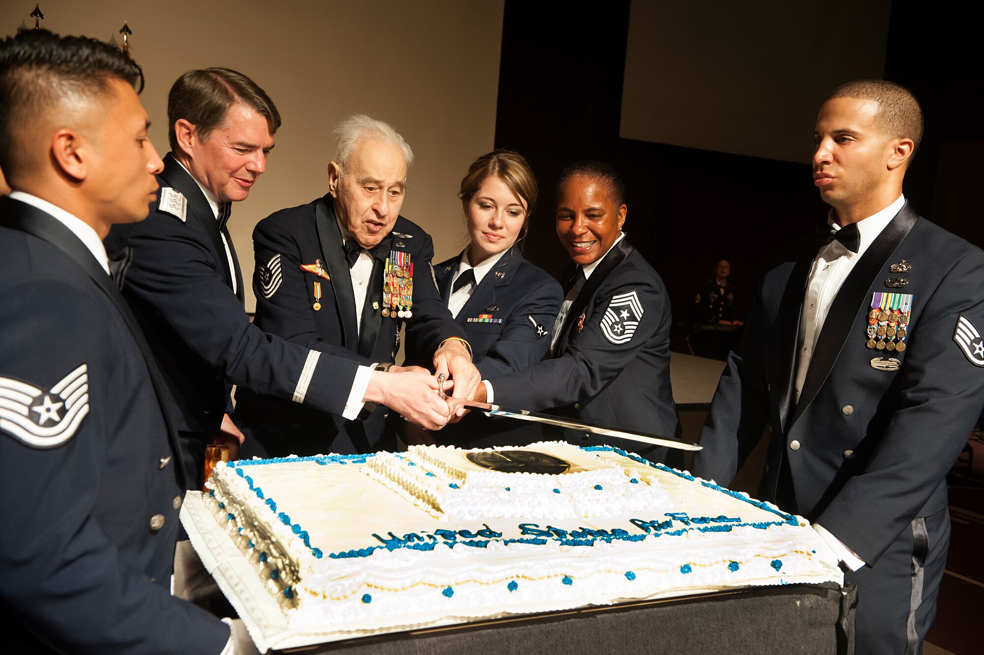 Retired Master Sgt. James “Gunner” Jackson and Airman Larissa Atkinson, 8th Operations Support Squadron aviation resource manager, as the most senior and junior Airmen, participate in the cake cutting ceremony with Lt. Gen Jan-Marc Jouas, 7th Air Force commander, and Chief Master Sgt. Shelina Fray, 7th Air Force command chief, during the 67th Air Force Ball in Seoul, Republic of Korea, Sept.13, 2014. It is tradition for the oldest and youngest Airmen in attendance to make the ceremonial first cut of the cake. (U.S. Air Force photo by Senior Airman Matthew Lancaster)