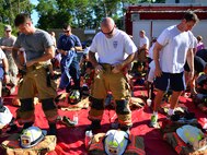 Eglin Air Force Base firefighters gear up Sept. 11. Fire department Airmen and civilians ascended the 11-story air traffic control tower carrying identification tags with the names of the 343 firefighters killed Sept. 11, 2001. The event ended on top of the tower with participants hanging the tag display over the balcony with an American Flag. (U.S. Air Force photo/Tech. Sgt. Cheryl L. Foster)