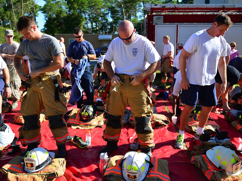 Eglin Air Force Base firefighters gear up Sept. 11. Fire department Airmen and civilians ascended the 11-story air traffic control tower carrying identification tags with the names of the 343 firefighters killed Sept. 11, 2001. The event ended on top of the tower with participants hanging the tag display over the balcony with an American Flag. (U.S. Air Force photo/Tech. Sgt. Cheryl L. Foster)