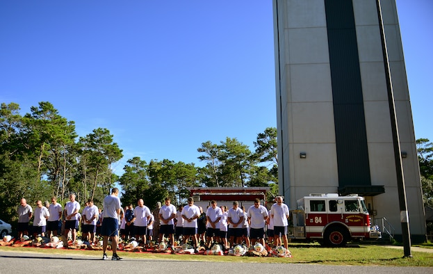Eglin Air Force Base firefighters participate in a prayer before donning their gear and completing their annual 9/11 memorial tower climb, Sept. 11.  Firefighters carried identification tags of each of the 343 firefighters killed on 9/11 to the top of the air traffic control tower to be placed on a memorial display.  Once at the top the name was read aloud.  The event ended with participants hanging the display over the balcony of the tower with an American Flag. (U.S. Air Force photo/Tech. Sgt. Cheryl L. Foster)