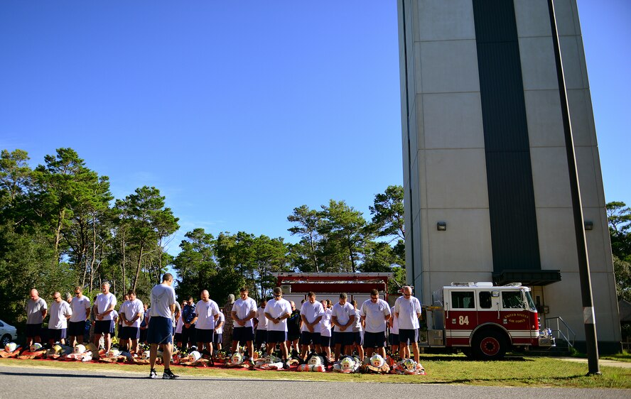 Eglin Air Force Base firefighters participate in a prayer before donning their gear and completing their annual 9/11 memorial tower climb, Sept. 11.  Firefighters carried identification tags of each of the 343 firefighters killed on 9/11 to the top of the air traffic control tower to be placed on a memorial display.  Once at the top the name was read aloud.  The event ended with participants hanging the display over the balcony of the tower with an American Flag. (U.S. Air Force photo/Tech. Sgt. Cheryl L. Foster)