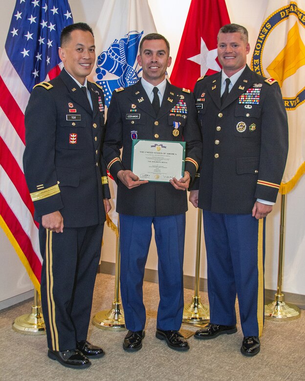 SAN FRANCISCO - (Sept. 24, 2014) - U.S. Army Corps of Engineers San Francisco District Deputy Commander Maj. (P) Adam J. Czekanski received the Soldier's Medal from South Pacific Division Commander Brig. Gen. Mark Toy for his actions of valor and heroism earlier this year when he jumped onto the tracks as a commuter train was approaching to save a fellow rider who had fallen due to an apparent seizure.  The Soldier's Medal is the U.S. Army's highest for valor or heroism in a non combat situation.  Pictured from left are Toy, Czekanski and San Francisco District Commander Lt. Col. John C. Morrow.  Czekanski, who has served three combat tours, two in Afghanistan and one in Iraq, has also received three Bronze Star medals one Purple Heart medal, credited his years of military training as he quickly assessed the situation and jumped into action to save a stranger while placing himself in imminent danger.