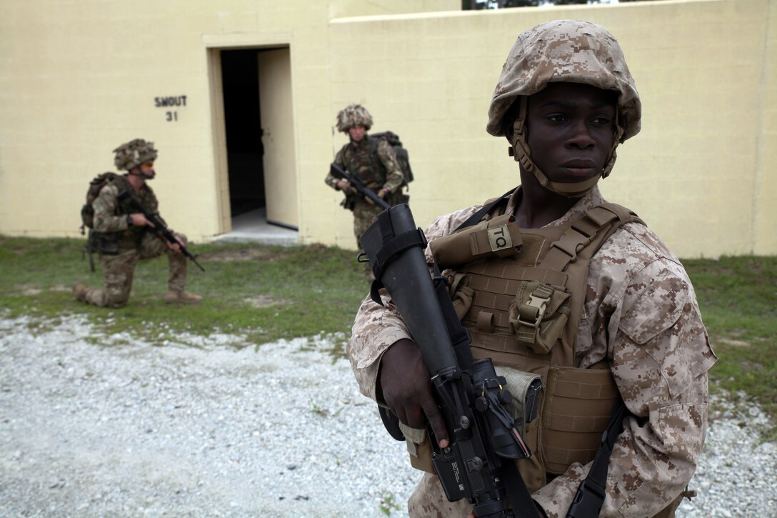 Lance Cpl. Dwayne M. Adams, an intelligence analyst with 2nd Intelligence Battalion, II Marine Expeditionary Force, and a native of the Bronx, provides security during a patrol exercise conducted with British soldiers from 5,6, and 7 Military Intelligence Battalions, 1 Intelligence Surveillance Reconnaissance Brigade, during Exercise Phoenix Odyssey on Sept. 14, 2014. The day’s training focused on Tactical Site Exploitation (TSE), where the Marines and their British counterparts shared their techniques in gathering intelligence in the field. The two forces are co-located in a Military Operations in Urban Terrain training facility on Camp Lejeune for the nearly week long, scenario driven, bilateral exercise.