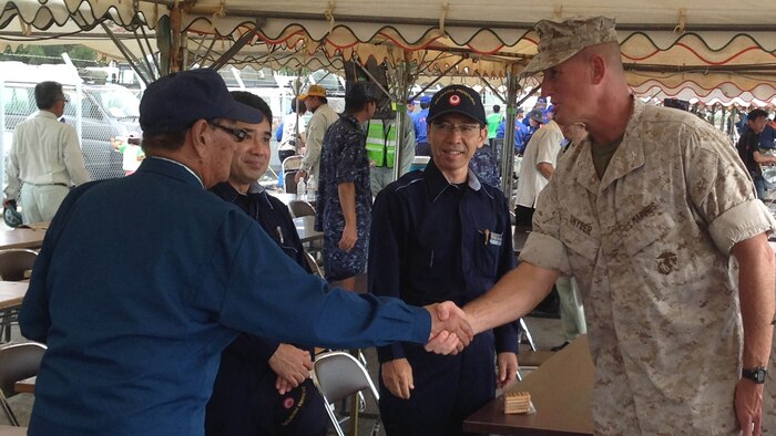 Governor Hirokazu Nakaima, left, shakes hands with Col. Christopher B. Snyder,Sept. 6 during a day of humanitarian assistance and disaster relief training on and around Miyako Island. The drills marked the first time members of the Okinawa Prefectural Government hosted a series of humanitarian assistance and disaster relief drills with full-fledged participation by the Japan Self-Defense Forces and U.S. Marines.  Nakaima is the Governor of Okinawa Prefecture and Snyder is the deputy commander with Marine Corps Base Camp Butler, Marine Corps Installations Pacific. 