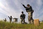 Spc. Braydon Gear, right, a cavalry scout with 4th Squadron, 9th Cavalry Regiment, trains with an M203 grenade launcher, Aug. 25, 2014 at the Camp Robinson Maneuver Training Center in Little Rock, Arkansas, as part of the 11B10 Infantrymen course at the 233rd Regiment Regional Training Institute of the Arkansas National Guard. Gear was one of the first three active component Soldiers attending reclassification training under the Active Component 2 Reserve Component pilot program at Fort Hood, Texas.