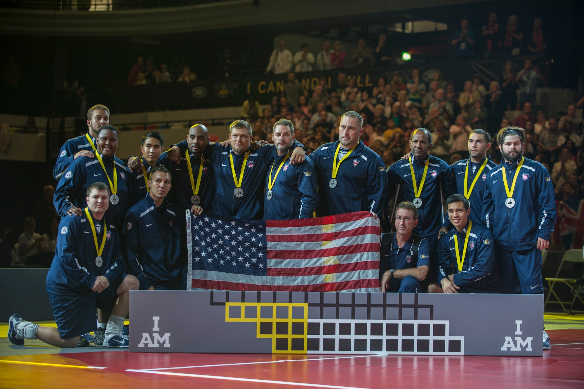 The USA Team poses for a picture as they placed second in the sitting volleyball finals at the Invictus Games Sept. 14, 2014, in London. Great Britain defeated the U.S. in a best-out-of-five match. The Invictus Games featured athletes competing in various Paralympic-style events, including swimming, track and field, seated volleyball, wheelchair basketball, and wheelchair rugby, among others. (U.S. Navy photo/Mass Communication Specialist 1st Class (SW) Mark Logico)
