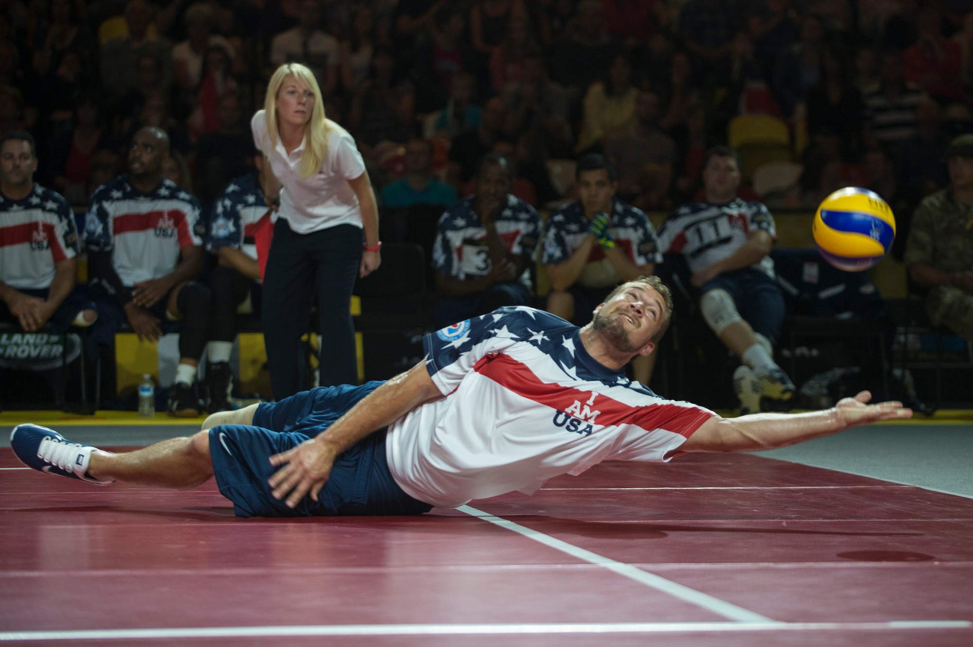 Navy Hospital Corpsman 2nd Class Max Rohn reaches for the ball during the sitting volleyball finals at the inaugural Invictus Games Sept. 14, 2014, in London. Great Britain defeated the U.S. in a best-out-of-five match. The Invictus Games featured athletes competing in various Paralympic-style events, including swimming, track and field, seated volleyball, wheelchair basketball, and wheelchair rugby, among others. (U.S. Navy photo/Mass Communication Specialist 1st Class (SW) Mark Logico)
