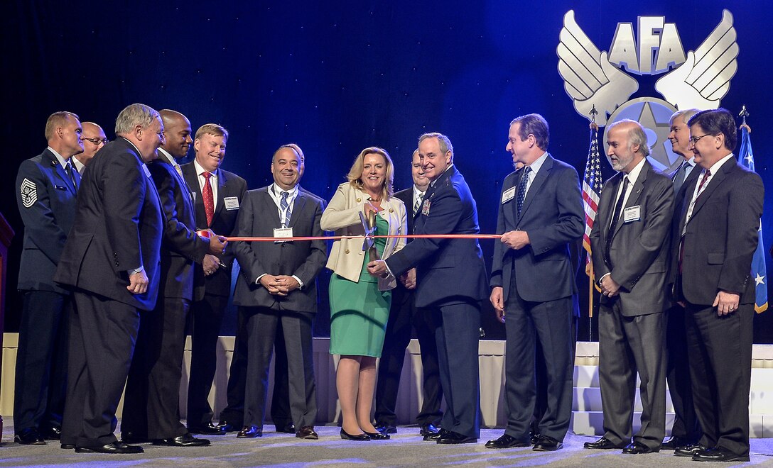 Secretary of the Air Force Deborah Lee James (center left) and Air Force Chief of Staff Mark Welsh (center right) cut the ribbon at the ceremony officially opening the 2014 Air Force Association's Air & Space Conference and Technology Exposition September 15, 2014, in Washington D.C. (U.S. Air  Force photo/Michael J. Pausic)