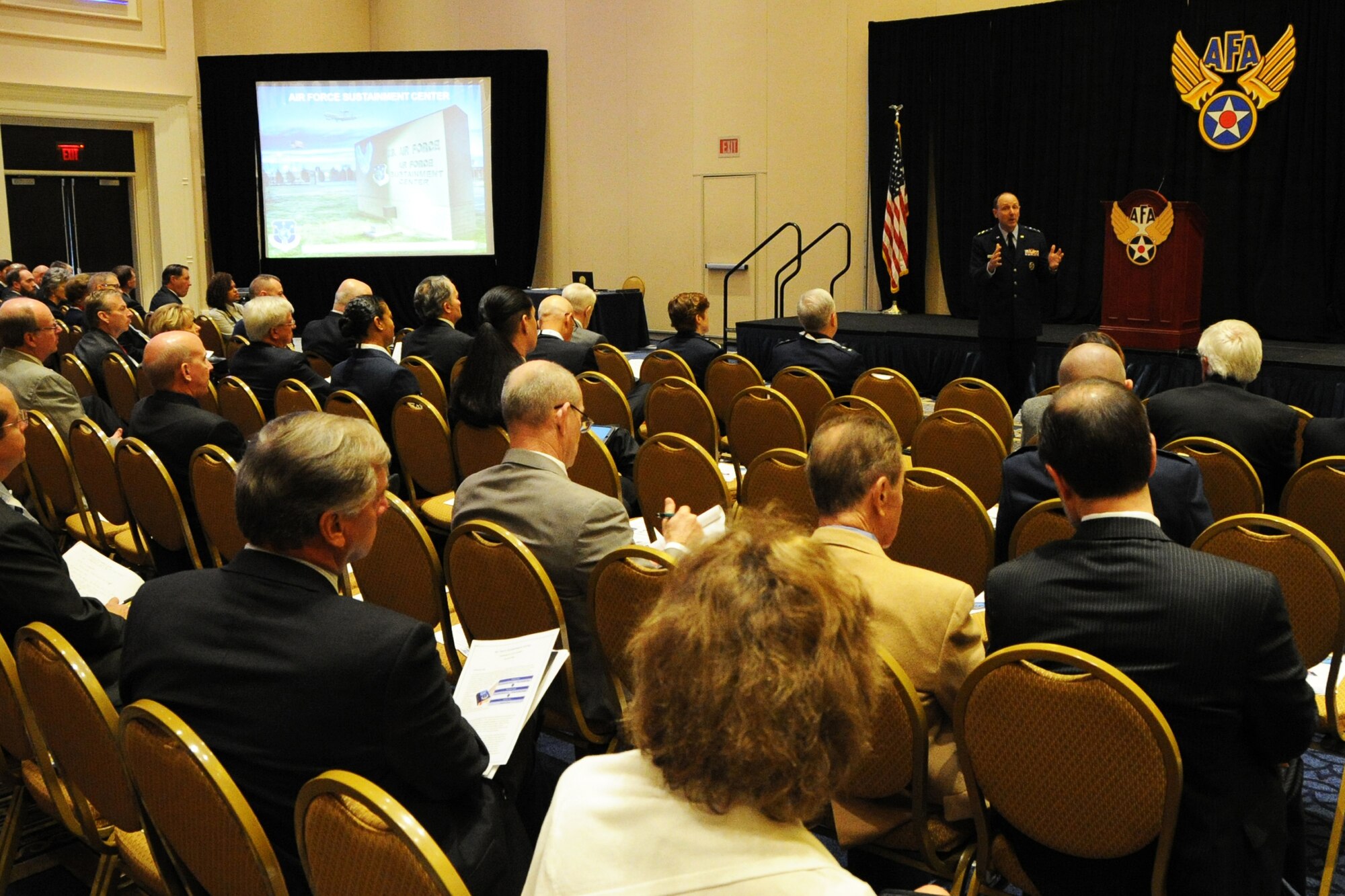 Attendees listen to a presentation from Lt.Gen. Bruce Litchfield during the Air Force Association's 2014 Air and Space Conference Sept. 15, 2014, in Washington, D.C. As the Air Force Sustainment Center commander, he ensures the Center provides operational planning and execution of Air Force Supply Chain Management and Depot Maintenance for a wide range of aircraft, engines, missiles, and component items in support of Air Force Materiel Command missions. (U.S. Air Force photo/Staff Sgt. Matt Davis)