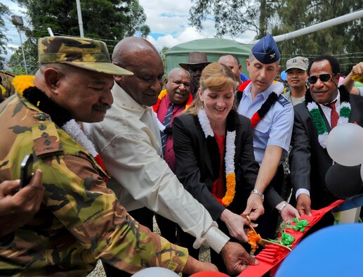 Dignitaries from the Papua New Guinea Defense Force, PNG government, U.S. Embassy and Pacific Air Forces cut the ribbon on the newly constructed girls’ dormitory at Togoba Secondary School in Mount Hagen, Papua New Guinea, during the closing ceremony for Pacific Unity 14-8. PACUNITY helps cultivate common bonds and fosters goodwill between the U.S. and regional nations through multi-lateral humanitarian assistance and civil military operations.  (U.S. Air Force photo by Tech. Sgt. Terri Paden/Released)                               