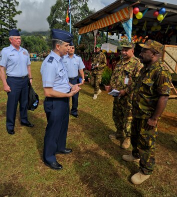 Col. Michael Addison, Pacific Air Forces deputy director for logistics, installations and mission supports, talks with his Papua New Guinea Defense Force counterparts before the closing ceremony for Pacific Unity 14-8. PACUNITY helps cultivate common bonds and fosters goodwill between the U.S. and regional nations through multi-lateral humanitarian assistance and civil military operations.  (U.S. Air Force photo by Tech. Sgt. Terri Paden/Released)                               
