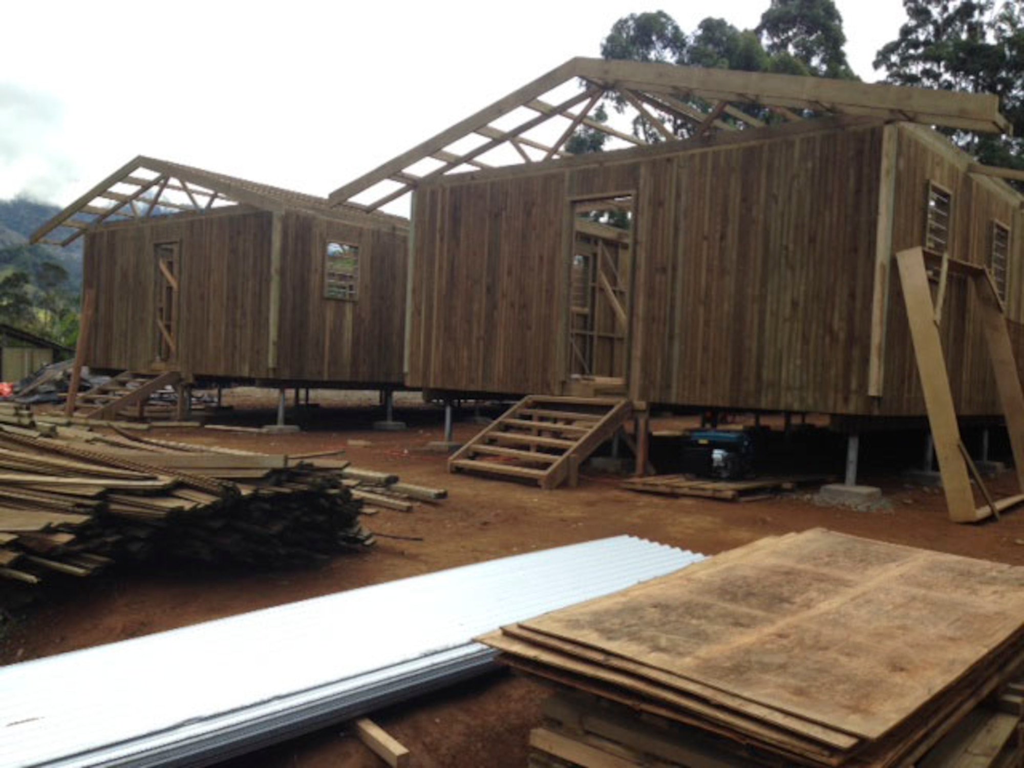 Members of the Hawaii Air National Guard 154th Civil Engineer Squadron have been working on the construction of two new dormitories to be used for female students at Togoba Secondary School in Mount Hagen, Papua New Guinea, as part of Pacific Unity 14-8. PACUNITY helps cultivate common bonds and fosters goodwill between the U.S. and regional nations through multi-lateral humanitarian assistance and civil military operations.  (U.S. Air Force photo by Airman 1st Class Jaimie Aquino/Released)                               