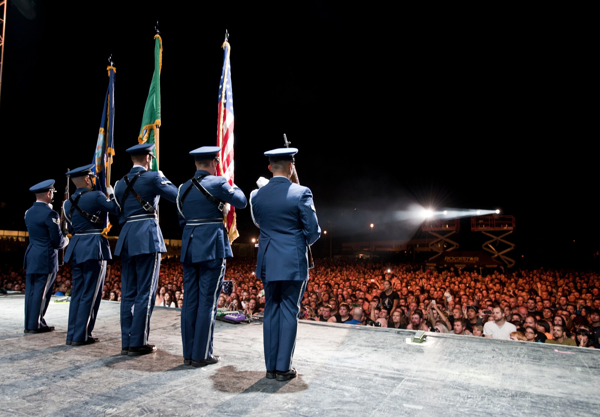 Members from the Fairchild Air Force Base honor guard perform the colors on stage for thousands of fans during the “Rock Hard at the Park” concert tour Sept. 11, 2014, in Post Falls, Idaho. The concert highlighted multiple rock bands and had a special patriotic ceremony to highlight Sept. 11.  (U.S. Air Force photos by Staff Sgt. Veronica Montes/Released)