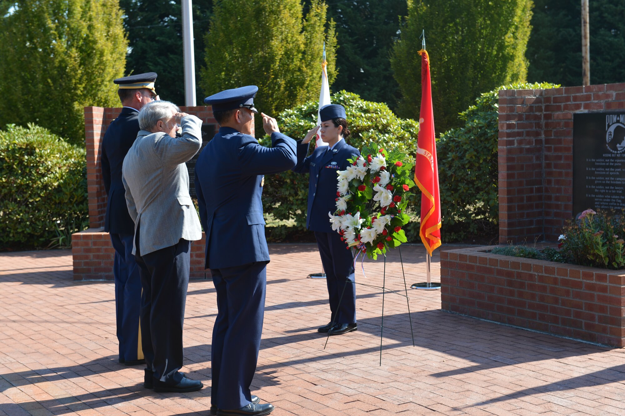 From left to right, Col. Charles Hodges Jr. Joint Base Lewis-McChord installation commander, William Wilson, Vietnam War POW/MIA, Col. David Kumashiro, 62nd Airlift Wing commander, salute after laying the wreath on a stand Sept. 15, 2014, during the POW/MIA wreath laying ceremony at Joint Base Lewis-McChord, Wash. Wilson was captured Dec. 29, 1972, and was held in the “Hanoi Hilton” prison before moving to the “Zoo” prison during the Vietnam War. He returned to U.S. control on the last C-141A out of Hanoi on March 29, 1973, during Operation Homecoming. (U.S. Air Force photo/Airman 1st Class Keoni Chavarria)