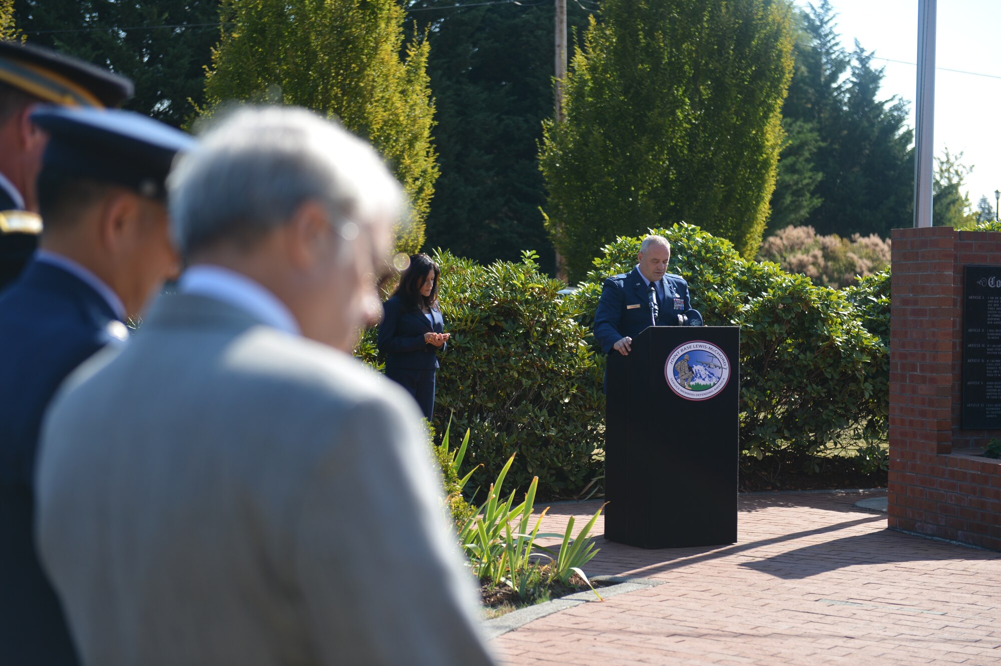 Service members and civilians bow their heads as Maj. John Shipman (right), 62nd Airlift Wing chaplain, delivers the prayer Sept. 15, 2014, during the POW/MIA wreath laying ceremony at Joint Base Lewis-McChord, Wash. The wreath laying ceremony was held in remembrance for service members that were either prisoners of war or missing in action as JBLM kicked off Remembrance Week. (U.S. Air Force photo/Airman 1st Class Keoni Chavarria)